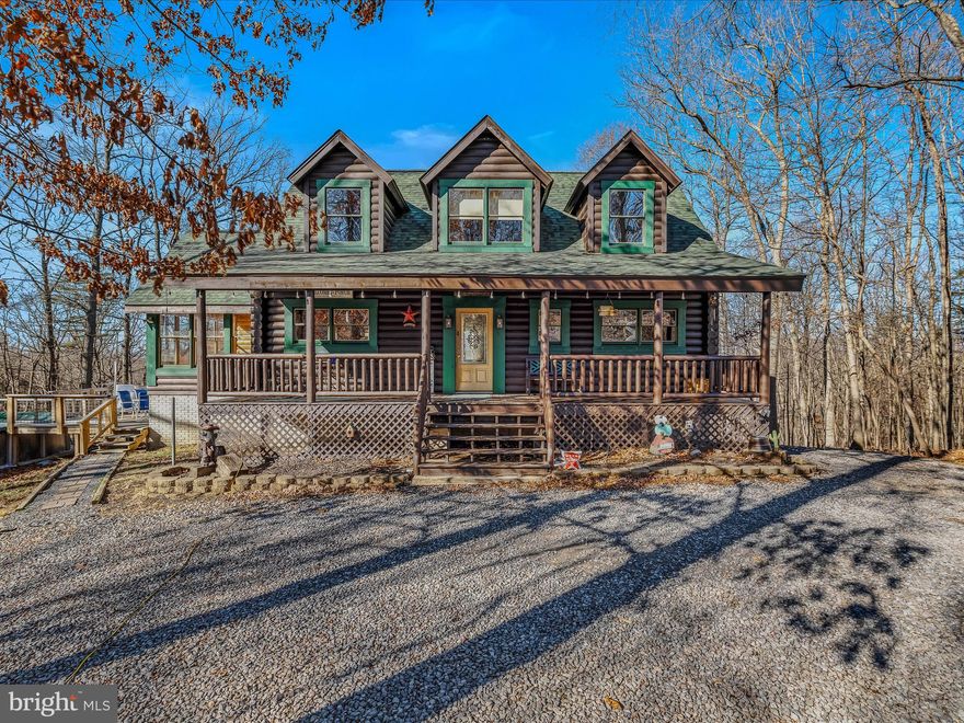 Spacious, well maintained log home with all of the comforts on over 5 acres.  Great location with paved roads , but in the country and private.  Enjoy the large outside deck, covered porch, and swimming pool in the warm months.  Vaulted ceilings with plenty of natural light and a mountain view.  Wood stove in the living room, central  heat/air, breakfast bar, and a huge sunroom are nice interior touches.  The bottom level has a spare bedroom, a pool table, a bar, and a kitchen for entertaining. If you love the outdoors, you will love this home.  Plenty of woods, wildlife, and a pond stocked with fish. There is a bedroom and a bathroom on each level for convenience.  Lot of wood touches which project a warm feel upon the home.