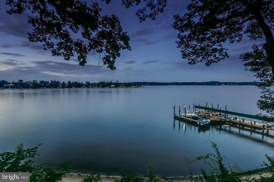 Breathtaking estate is the ultimate retreat set on about 6.5 acres with an arms-length list of amenities.  Words are inadequate. Pictures will give you some idea, but a visit will cement your desire to own this property. More than 1.8 million dollars of renovations and upgrades. Recent contractor estimates the cost to replace just the main house is almost $4.7 million. Privacy galore but not remote from civilization. Power and telephone is reliably provided by underwater cable; no need for generator. Both AT&T and Verizon provide mobile service and satellite dish provides cable TV.  Home is designed for entertaining either family-style, or, extravagantly in a more formal style.  Gourmet kitchen provides enough space to prepare a banquet.  However, when you wish to be alone, the landscape vistas and wildlife will entertain you! The rain on the copper roof will lull you to sleep.  Any guests may moor at your private docks.  Sail or motor boats are welcome. You may receive your guests in a marble floored rotunda entry.  Accommodate overnight guests in the main house, a detached cottage with its own kitchen, or, uniquely, in the renovated, detached water tower with 360 degree views (currently used as an office).  Be careful, they may never leave!  Stage a murder mystery game in the basement with its massive built-in safe or store an extensive wine collection.  The main house even has room for an addition if you just can't get by on 6100 sf of space (not counting the cottage, basement and water tower) The island itself spans 16 acres with over 0.5 miles of pristine waterfront protected by granite stone revetment, bulkhead, and sandy beach. The location is on the south side (allows you to avoid congestion of bridge traffic).  Close to the historic Annapolis waterfront, convenient to Washington, DC, steeped in the nation's history and diverse culture, you and your family and guests may partake of excellent dining, shopping and sightseeing opportunities.  Odds are, however, you will be sorely tempted to remain within your own tranquil and beautiful environs.  The house runs 197 feet with an incomparable view looking south by southeast one and one-half miles across Round Bay. Built with materials of the highest quality; the marble floors are imported from Belgium, The wood floors are made of wide plank mahogany or original southern pine.  Roofs are solid copper with copper flashing, gutters, downspouts and snow guards. Eight chimneys serve four working and four decorative fireplaces.  Coffered ceiling, crown molding and wrought iron windows with leaded mullions add architectural interest. Sixteen hundred feet of deep-water frontage include 170 feet of sandy beach. Three hundred sixty feet of commercial quality pier is outfitted with three electric boat lifts, one deep water boat slip for a 110-foot yacht, 230 volt, 100 amp electric service, good lighting and potable water.  Outbuildings include a 330 sf office atop the converted brick water tower with a 360 degree water view, and a guest or caretaker cottage.  The latter is a 1-bedroom/1 bath (with full kitchen and screen porch) 850 sf residence.  The water tower office has mahogany trim, bamboo floors, unique lighting & bracing with AC & heat as well as a functioning wood stove.  A VHF and HF antenna allow radio communication to boats and stations around the world. Round Bay and Little Round Bay completely surround the island, creating an ideal "safe harbor" against storm and those who would do harm to a wealthy owner. Access is provided by deep water (16 feet minimum) from the Chesapeake Bay and limited access highway from I-95, I-97, Rte 50; BWI, Reagan, and Dulles airports, as well as the local Edgewater airport; on island landing space for Medivac helicopter.  Must see to believe!