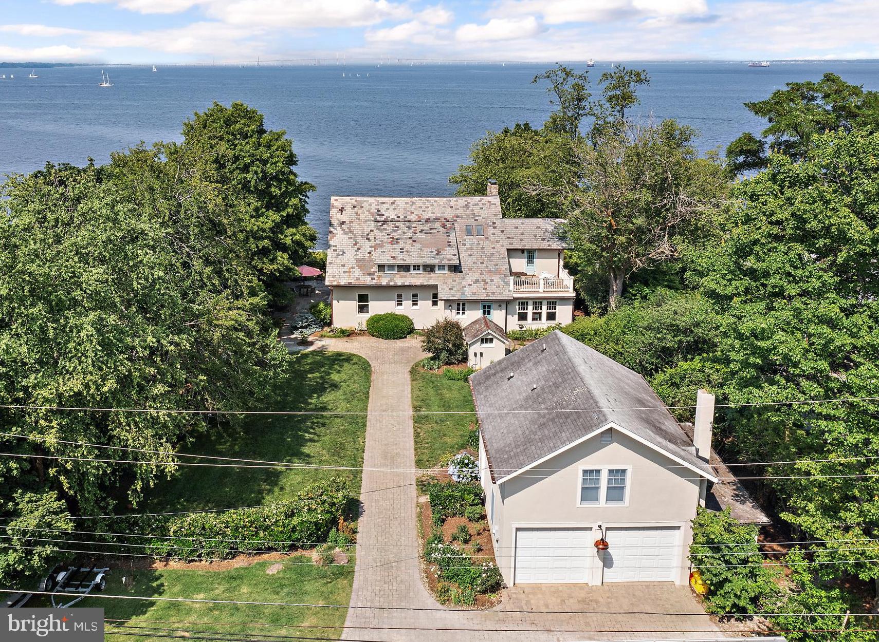 2 River with its stunning water views of the Severn River and of the Chesapeake Bay epitomizes the Annapolis Lifestyle! Located in this beloved multi-generational community of Bay Ridge, this exquisitely renovated classic home seamlessly blends the timeless updates and fabulous original detail such as leaded glass windows and brass chandeliers. The main level has the most incredible, breezy waterside 3-season porch for entertaining, lounging and napping with panoramic views to activities on the bay. The newly renovated chef's kitchen has painted inset cabinets, white marble counters, top of the line appliances and beautiful views to the water and rear gardens. The adjacent mudroom/pantry with restored cabinets, custom dog wash, powder room and convenient laundry. The main level also boasts two bedrooms/offices, a full and a half bath. The upper level features 4 bedrooms including a large primary suite with sitting room, private balcony, walk-in closet and 2 spacious additional bedrooms all with lovely water views, and 2 full renovated baths. The guest suite/office over the oversized garage has wood floors, a kitchen and full bath. The original screened in gazebo will be your favorite place in the world to eat crabs and host friends. The exceptionally private lot has lush mature landscaping, lots of hardscape for dining, grilling and taking in the sensational water views. Also, geothermal heating and a waterproofed, full height walk-out basement with amazing storage but just too many details to list all! Bay Ridge is famous for being the most desired and most amenity rich neighborhood in Annapolis with its extraordinary community beaches, large marina with the renovated clubhouse, playground, pickleball and basketball courts, ball fields, and stunning waterside pool with yet another reservable club house. *House comes with a transferral pool bond.* This fun and lively community is well known for its magical events year round that everyone looks forward to including the Blue Angels flyover and its 4th of July picnic on the beach. Bay Ridge is minutes from Downtown Annapolis and Eastport, has convenient access Rt. 50 , 97, Washington, Baltimore and BWI. This one will not disappoint! Non-riparian waterfront.