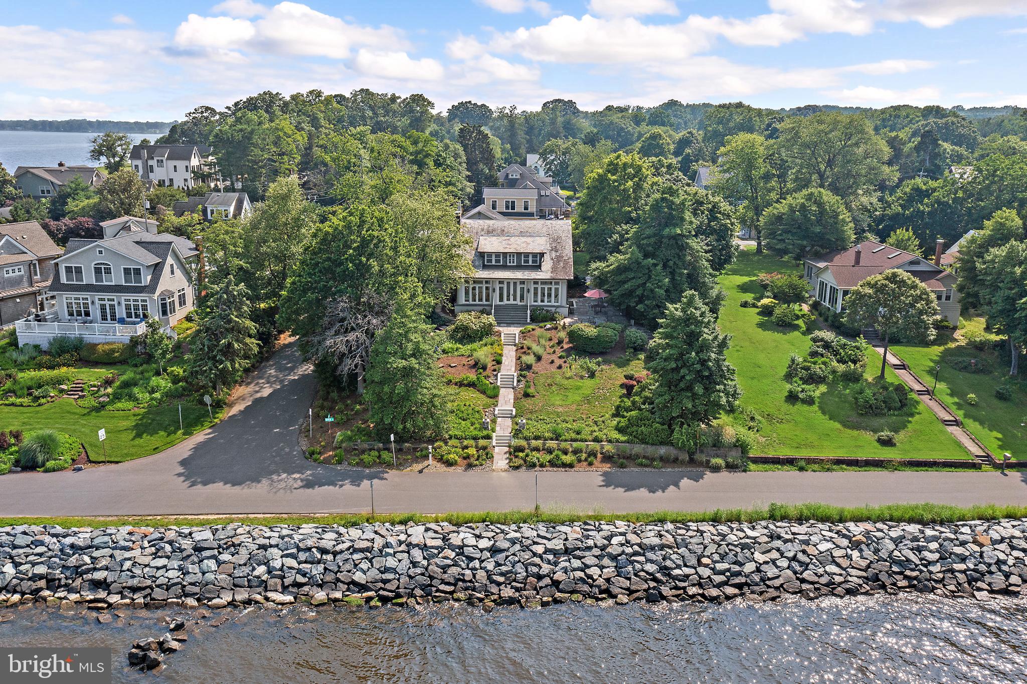 2 River with its stunning water views of the Severn River and of the Chesapeake Bay epitomizes the Annapolis Lifestyle! Located in this beloved multi-generational community of Bay Ridge, this exquisitely renovated classic home seamlessly blends the timeless updates and fabulous original detail such as leaded glass windows and brass chandeliers. The main level has the most incredible, breezy waterside 3-season porch for entertaining, lounging and napping with panoramic views to activities on the bay. The newly renovated chef's kitchen has painted inset cabinets, white marble counters, top of the line appliances and beautiful views to the water and rear gardens. The adjacent mudroom/pantry with restored cabinets, custom dog wash, powder room and convenient laundry. The main level also boasts two bedrooms/offices, a full and a half bath. The upper level features 4 bedrooms including a large primary suite with sitting room, private balcony, walk-in closet and 2 spacious additional bedrooms all with lovely water views, and 2 full renovated baths. The guest suite/office over the oversized garage has wood floors, a kitchen and full bath. The original screened in gazebo will be your favorite place in the world to eat crabs and host friends. The exceptionally private lot has lush mature landscaping, lots of hardscape for dining, grilling and taking in the sensational water views. Also, geothermal heating and a waterproofed, full height walk-out basement with amazing storage but just too many details to list all! Bay Ridge is famous for being the most desired and most amenity rich neighborhood in Annapolis with its extraordinary community beaches, large marina with the renovated clubhouse, playground, pickleball and basketball courts, ball fields, and stunning waterside pool with yet another reservable club house. *House comes with a transferral pool bond.* This fun and lively community is well known for its magical events year round that everyone looks forward to including the Blue Angels flyover and its 4th of July picnic on the beach. Bay Ridge is minutes from Downtown Annapolis and Eastport, has convenient access Rt. 50 , 97, Washington, Baltimore and BWI. This one will not disappoint! Non-riparian waterfront.