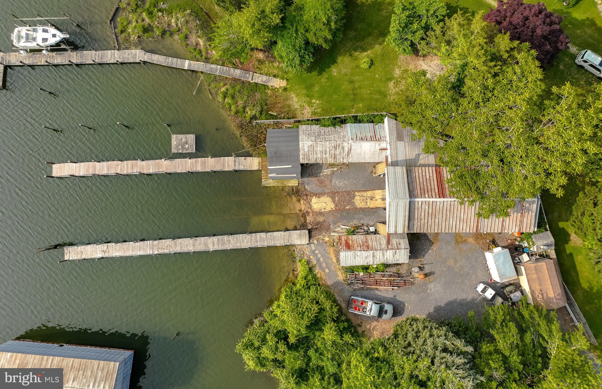 Mid-Chesapeake Bay Commercial Waterfront Property located in Solomons Maryland
2 -100ft piers, 10 foot water depth, 25Ft X 60 Ft building covering railway. 200 foot of railway tracks.
.29 acres on Mill Creek located close to the Patuxent River, Chesapeake Bay and Cove Point LNG Plant.
Over 3400 SQFT of covered area. Possibility of multiple slips. Operate you boat or marine business from this excellent location. Serious Inquires only. Shown by appointment.
