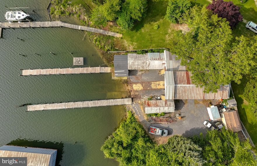 Mid-Chesapeake Bay Commercial Waterfront Property located in Solomons Maryland
2 -100ft piers, 10 foot water depth, 25Ft X 60 Ft building covering railway. 200 foot of railway tracks.
.29 acres on Mill Creek located close to the Patuxent River, Chesapeake Bay and Cove Point LNG Plant.
Over 3400 SQFT of covered area. Possibility of multiple slips. Operate you boat or marine business from this excellent location. Serious Inquires only.  Shown by appointment.