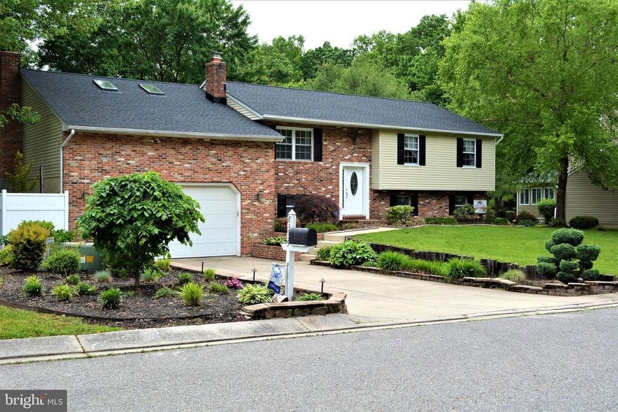 THIS IS NOT YOUR TYPICAL SPLIT FOYER! Everything you could want in a home! This beautiful 2,720 SF, 4 bedroom, 3 full bathroom split level home has recently (April 2019) been upgraded with a new roof, water heater, shutters, and skylights.  It features updates throughout, including hardwood floors, soft close kitchen cabinets, granite countertops, stainless steel appliances, recessed lighting, a newly redone master bathroom shower, and two brick fireplaces.  This home boasts a two and a half car garage, huge flat backyard, additional storage space, large laundry/mud room, access to a community pool, and a great family oriented neighborhood within a top rated school district. Open concept floor plan with a large deck space   perfect for entertaining. Move in ready!
