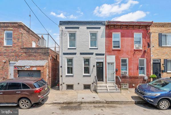 Newly renovated with luxury finishes throughout, 2001 S Mildred St is a semi-detached, 2-story home offering 2 bedrooms, 1.5 bathrooms, a private patio, and a prime East Passyunk location. A quiet, low-traffic block leads to the freshly painted brick exterior. Stepping inside, you'll immediately notice the bright, open, and airy feel of the main level, aided by high ceilings and modern floors. Tall windows pour natural light into the living room, where there's plenty of space for hanging out and entertaining. The highlight of the home is surely the gleaming kitchen, boasting white inset cabinetry, quartz counters, stainless steel appliances, including a dishwasher, and a distinctive green tile backsplash. At the center is an island with seating and pendant lights overhead. Off the kitchen are a convenient powder room and the laundry. Out back, the quiet patio is the perfect spot for summer barbeques and al fresco dining. Up on the second level, there's a large, sunlit primary bedroom with a ceiling fan and two closets at the front. Another spacious bedroom and a full bathroom with modern tile are down the hall. Completing the home is an expansive basement with tons of extra storage space. Not only is 2001 S Mildred St a fantastic home, but its equally fantastic location earns a Walk Score of 95! Just around the corner, the Bok Building is an old school turned community workplace hosting diverse small businesses, including a preschool, a dog daycare, art galleries, non-profits, eateries, and a rooftop lounge. A few blocks west, vibrant East Passyunk Ave is lined with top restaurants, friendly shops, and lively entertainment. Stores like Target, ACME, Lowe's, and IKEA are nearby off of Snyder Ave, plus there's easy access to public transit, Broad St, the Sports Complex, I-95, and South Jersey. Schedule your tour today!