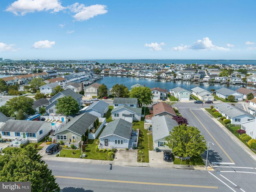 Welcome to your dream vacation property in North Ocean City, Maryland, perfectly situated just below the Delaware line, offering you the best of both states' coastal treasures. This charming single-level property is the epitome of comfort and convenience, providing you with an unforgettable beach retreat. As you step inside, you'll immediately feel a sense of warmth and relaxation. The open-concept layout seamlessly connects the living, dining, and kitchen areas, creating a spacious and inviting atmosphere. Natural light floods the space through multiple windows, illuminating the vaulted ceilings and highlighting the coastal-inspired décor and furnishings that are negotiable. The living area beckons you to unwind and enjoy quality time with family and friends. Sink into the plush sectional sofa and catch up on your favorite shows on the flat-screen TV flanked by built-in shelving. The fully equipped kitchen is a haven for entertainment, featuring modern, stainless appliances, a center island with seating, ample counter space, decorative pendant light, and beverage refrigerator. This property boasts three thoughtfully designed bedrooms, each offering a serene and restful ambiance. The primary suite hosts tasteful finishes and décor that encourage relaxation. All bedrooms are tastefully decorated and equipped with ample storage space to keep your belongings organized. Stepping outside, you'll discover a patio area where you can bask in the warm sunshine or enjoy a glass of wine by the fire as the sun sets on another perfect day. This prime location offers easy access to both Maryland and Delaware beaches. Spend your days soaking up the sun, experiencing the bay, or taking refreshing dips in the Atlantic Ocean. The desirable Caine Woods community offers no HOA or condo fee where you can easily find an abundance of nearby restaurants, shops, and entertainment options within reach. Create lasting memories, relax, and experience the best of the Maryland and Delaware coastlines.