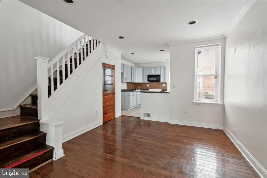 Step through the new steel front door from the welcoming porch into this light-filled, airy home. The lovely living and dining rooms feature neutral designer paint, beautiful crown molding, and light Pergo flooring. The fully upgraded kitchen boasts black appliances, a stainless steel sink, a stunning glass tile backsplash, and ceramic flooring for a complete, modern look. Adjacent to the kitchen, you'll find a full laundry room with access to the backyard.

Upstairs, the second floor offers three spacious bedrooms, with fresh carpeting throughout. The renovated bathroom includes ceramic tile in the tub area, a stylish ceramic floor, and a new window. Additionally, there is a large basement, perfect for storage or for you to finish for additional living space.