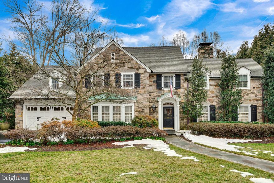 Classic Main Line elegance meets modern living at 404 Wynmere Road, a beautifully maintained stone Colonial situated on a charming street in the award-winning Lower Merion School District. Expanded and thoughtfully renovated, the home blends timeless character with modern updates, including a stunning chef’s kitchen and private in-law suite designed for today’s lifestyle.
The gourmet kitchen serves as the heart of the home and a natural gathering place, featuring top-of-the-line appliances, Venetian plaster walls, hardwood floors, double ovens, a gas cooktop, built-in microwave, wine refrigerator, two islands with prep sinks, two dishwashers, and an oversized pantry. French doors open to the patio, creating seamless indoor-outdoor flow ideal for entertaining and al fresco dining. A nearby laundry room provides convenient access to a second patio with a built-in barbecue.
Elegant living spaces include a formal dining room with corner built-ins and deep windowsills, a butler’s pantry connecting the kitchen to the garage, and a welcoming living room with wood-burning fireplace and French doors leading to a charming covered stone patio. A cozy den with a second fireplace and patio access, along with a beautifully appointed powder room, completes the main level.
The second floor is accessible by two staircases and offers a spacious primary suite with two closets, a built-in dresser, and a bath with soaking tub and walk-in shower. A private in-law suite features generous built-ins and an ensuite marble bath with separate tub and walk-in shower. Two additional bedrooms and a full hall bath complete the level.
The third floor provides a flexible bonus space ideal for a home office or studio, a full bath with standalone tub, and a large cedar closet. The finished lower level offers additional recreation space, abundant storage, and a utility room with two 75-gallon hot water heaters.
Beautifully landscaped grounds create a peaceful outdoor retreat with mature plantings and lush greenery. Ideally located just minutes from Suburban Square, Narberth parks, restaurants, and Center City Philadelphia, this exceptional home offers the perfect blend of classic Main Line charm and modern convenience.