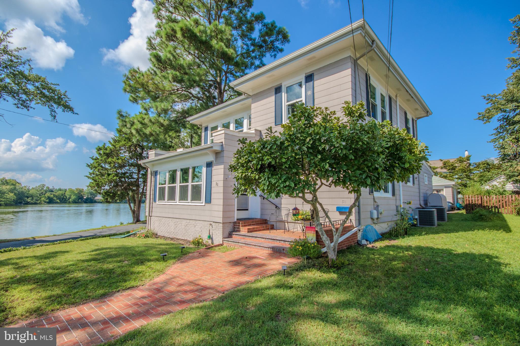 Experience breathtaking waterfront and unobstructed water views at this charming and meticulously maintained home on Johnson Pond in Salisbury, MD. Built in 1924, this beautiful property sits on a spacious .23-acre corner lot with exceptional road and water frontage, offering a rare blend of historic character and modern updates. From the moment you arrive, the inviting front porch sets the tone for relaxed waterfront living, perfect for enjoying morning coffee or evening sunsets over the water.
Offering nearly 2,000 square feet of living space, this home includes three large bedrooms and two full baths, ( one full bath on the main level ) providing plenty of room for family, guests, or a home office.
The spacious living areas feature a cozy fireplace, charming built-ins, and an abundance of natural light, creating a warm and inviting atmosphere. Many updates have been thoughtfully integrated to ensure modern comfort while preserving the home’s historic appeal. Some updates include all plumbing in the basement connected to the main line, bathrooms redone in 2020, kitchen remodel, A/C replaced on both floors, Oil boiler new in 2017, exterior trim painted, windows in sunroom replaced, new sliding door to deck and back screened door, fence installed, light fixtures and ceiling fans replaced etc....
Homes built in 1924 showcased quality materials, timeless architecture, and attention to detail—traits still evident in this remarkable property today. Don't worry that the updates have changed its' character and charm, that is not the case! You are getting the best of both worlds: quality and modern upgrades!
The property includes a two-car detached garage, a basement and attic for extra storage, and beautifully maintained landscaping and fencing that enhances its curb appeal. Whether relaxing on the porch, entertaining in the living areas, or soaking in the picturesque water views, this home offers a lifestyle that is both peaceful and inspiring.
Priced at $399,900, it is an exceptional value—move-in ready and situated in a one-of-a-kind location. With its' rich history, timeless architecture, and unbeatable setting, this is more than a home; it’s a waterfront retreat where memories are waiting to be made and coming home is such a pleasure.
Also includes the strip of land between Johnson's Mill Pond and Lakeside Dr. Account # 09-074104