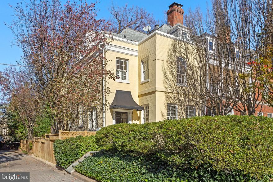 The handsome, traditional exterior of this lovely home belies the amazing surprises awaiting inside. Set on a quiet Cleveland Park block in the shadow of the National Cathedral, 3245 Klingle Road features abundant light, fabulous living spaces, and soaring ceilings in the dramatic, two-story circular dining room (18'5"), the living/family room (10'8"), primary bedroom (12'2") and office/playroom (10'3"). Walls of windows from the living/family room and primary bedroom overlook the exceptionally deep and private lot with deck, terraces and a 40' heated pool. A two-story window on the side of the home bathes the dining room in light, and Cathedral views can be seen from the upper levels. The large kitchen with breakfast area provides ample work and storage space. The primary bedroom with sitting area, dual walk-in closets and bath with soaking tub, dual vanities and shower, and a second bedroom with ensuite bath and original arched window are on the second level. The third level includes a skylit and open office/playroom with built-in seating, a third bedroom and third full bath. A large family room on the lower level has its own separate entrances, with walkouts to both off street parking and the side of the home. A fourth bedroom and fourth full bath on this level are perfect for guests or use as an au-pair suite. Laundry, utilities and storage are also found here. The remarkably deep lot is a rarity in this location, and the private, fenced rear grounds and pool offer a hidden oasis in the heart of the city. The welcoming and lovely front terrace provides yet another spot for gathering and entertaining. This special block is beloved for being tucked away, yet within walking distance the Cathedral, many of Washington's finest schools, metro, shops, restaurants and more. Location, location, location, plus an amazing house and lot - don't miss this opportunity!