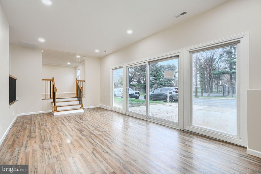 Welcome to this gorgeous 3BR/1BA completely updated semi-detached Anne Arundel County rancher. Nestled across the street from a public park with green space and basketball courts and just a few minutes to major commuter routes. Easily park 2 cars in the large concrete driveway and enter the front door to find a wonderfully modern dining space with recessed lighting, new trim, and new luxury vinyl flooring. To the left, you will find the enormous living area that offers tons of natural light via the sliding doors. This room has tall ceilings and recessed lighting. The beautiful kitchen features brand new stainless steel fridge, range, and microwave, a sealed/stained butcher block countertop, and all new matching hardware and plumbing trim. There is a convenient pantry located next to the fridge and built in to the wall. Head toward the large first bedroom and you will find access to the brand new air handler and duct work offering central heating and cooling. This spacious bedroom features new plush carpet, recessed lighting and a walk-in closet. The other 2 bedrooms in the home also boast brand new carpet and a ceiling fan/light combo. The stackable laundry is located in the hallway directly across from the water heater closet. The all new bathroom features tub/shower, new ceramic subway tile, new vanity, and all new bathroom hardware and trim. There is also a linen closet located in the bathroom. The spacious front yard opens to ever more green space thanks to the county park across the street. There is also a fully fenced rear yard including storage shed. The home has energy efficient spray foam insulation in both the attic and crawlspace providing BGE savings for many years to come. The newly installed HVAC system offers comfort heating and cooling. Come have a look before it's gone!