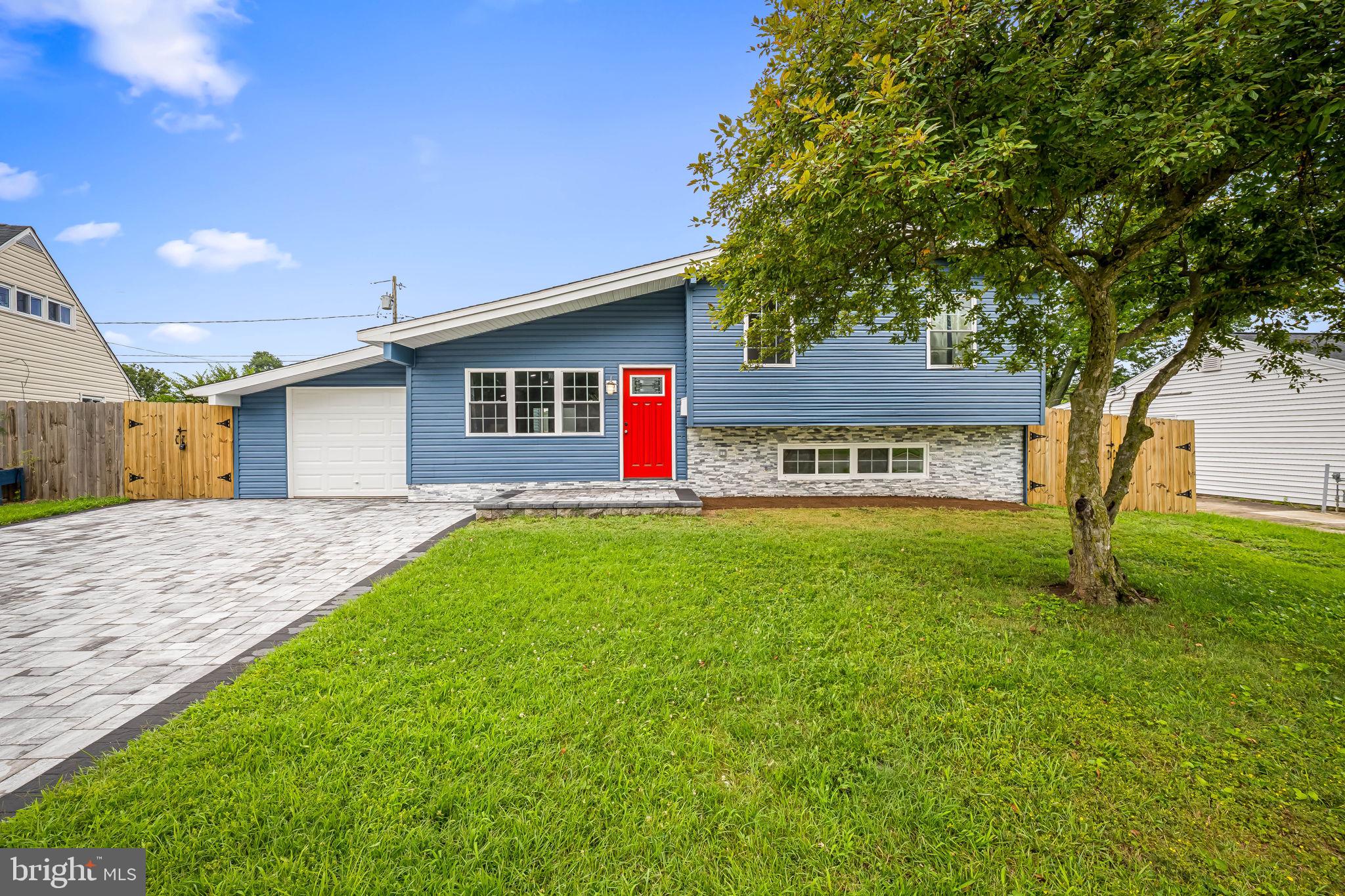 This fully renovated, nearly 2,000 SQFT 4 Bed / 2 Full Bath home is better than new, boasting three fully finished levels with Luxury Vinyl Plank and recessed lighting throughout, extra wide living and bedroom spaces with an open concept and half-vaulted ceilings on the main, wine bar and kitchenette, butler's pantry, an attached garage with interior access, 4-car custom driveway, and fully fenced rear yard with extensive hardscaping for your own personal entertainment oasis! Gourmet kitchen highlights include an oversized, 5-seater quartz peninsula, stainless steel appliances, pendant lighting, upgraded backsplash, and extra built-in cabinetry for storage. The second level offers three well-lit bedrooms with the first full bath. The lower level offers the 4th bedroom / den complete with sitting area, the second full bath with stall shower, dedicated laundry room with shelving, and rear walkout. Additional updates include new plumbing, electric, HVAC, water heater, vinyl windows, and architectural shingle roof. No expense has been spared!