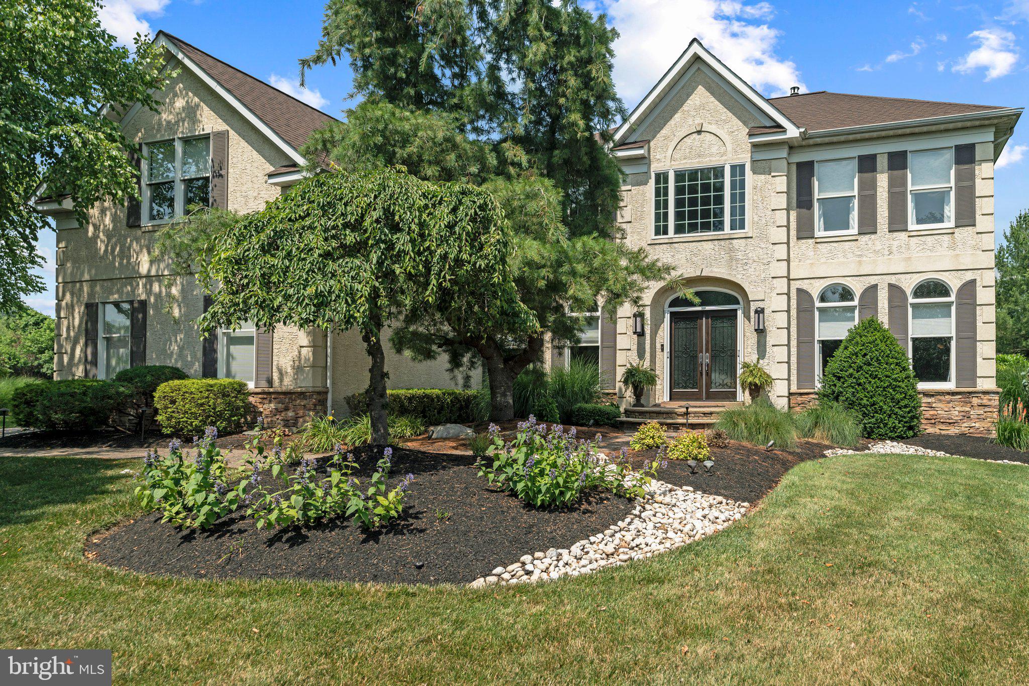 Welcome home to 8 Furlong Court, located on a quiet Cul de sac, in desirable Stoney Ford Estates. This well maintained 5 bedroom 4.5 bathroom home in the Council Rock School District is ideal and ready for making lasting memories. This inviting residence boasts stunning curb appeal, with lush landscaping lining the front walkway with a decorative custom double-door glass entry to a 2-story foyer. You are warmly embraced with a unique tin ceiling and wood flooring that seamlessly connects the Living room and Dining room, both rooms have hand crafted coffered ceilings. The first floor Home Office provides a quiet working space overlooking the front yard. The updated Kitchen with expanded cabinetry, has a bump out sink, granite counters, center island and stainless steel appliances: Bosch dishwasher, Sub Zero refrigerator, built-in oven and Wolf Range. The Kitchen overlooks the spacious family room with a unique distressed 2-story wooden ceiling a stone gas fireplace and motorized blinds. The open floor plan is perfect for entertaining. There is a convenient second staircase. From the hallway upstairs, you have a spectacular overlook from the bridge down into the Family Room and Foyer.
This home boasts a Primary Suite with 2 walk-in closets, a sitting area and luxurious en suite bathroom with soaking tub, enclosed shower, and dual vanity. There are 4 additional spacious bedrooms, another full updated hall bathroom and a Jack and Jill bathroom serviced between bedrooms 4 and 5. Attic access through the hall bedroom, equipped with a fan and ample storage space.
Off the Family room is the updated Laundry room with counter space and cabinets which leads you to a 3 car Garage with carriage house doors, side mounted openers including shelving, peg boards and motorized overhead storage system. Head to the outdoor oasis through double door sliders. The yard is lined with trees and an aluminum maintenance-free fence with 4 gates. The multi level travertine patio has an outdoor kitchen area with a DCS natural gas grill, perfect for entertaining. There is a large inground saltwater system spa with remote control, natural gas firepit and torches, low voltage landscape lighting throughout the property including wall and patio lighting. Underground sprinkler system is offered in the front and side yards. The well designed fully finished basement has an egress with double French doors that lead to the backyard. There is a full bathroom, partitioned office or 6th bedroom, possibly an In-law suite, wet bar, wine refrigerator, bar refrigerator, dishwasher, game room and home theater area to cuddle up and watch movies. French drain sump pump connected to the whole-home generator. Sonos amplifier connected to outside patio rock speakers. State of the art HVAC, 2 zones, dehumidifier and purifier.
Don’t wait, this home is a rare find and an opportunity not to be missed!