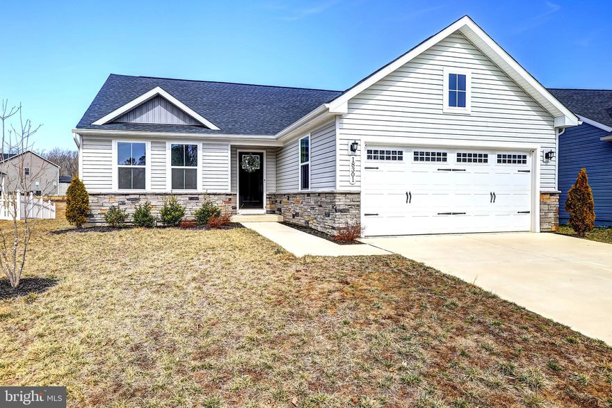 Experience the convenience of one-level living in this modern Grand Cayman ranch-style home, built in 2022. Nestled within the sought-after Pendleton golf course community in Caroline County, this residence is just minutes from I-95 and Route 1. Upon entering, you're welcomed into a spacious foyer (10x7.3), featuring luxury vinyl plank flooring and a convenient coat closet. To the right, access the unfinished basement (38.8x33.4) equipped with a full bathroom rough-in and an egress window, and offering endless customization possibilities such as a man cave, home office, recreational space, or movie theater. Bedroom #3, a full hallway bathroom, and the garage entrance are also located to the right, while Bedroom #2 is situated to the left of the foyer. The main living area boasts an open-concept design, seamlessly connecting the kitchen, dining, and family room - which is so desirable for today's lifestyles! The kitchen is equipped with stainless steel appliances, Granite countertops, an island, pull-out shelves in all lower cabinets, recessed lighting, and a spacious pantry. A sliding door leads from the dining area to the backyard. A secondary pantry or storage closet is conveniently located in the hallway next to the laundry room (5x7). At the rear of the home, the owner's suite offers a generously sized walk-in closet (10.7x6) and a full bathroom featuring elevated double vanities and a tiled shower with a seat and glass doors. The Pendleton community provides top-notch amenities, including a pool, dog park, playgrounds, walking trails, sports courts, and trash pickup - all covered by the HOA. Golf enthusiasts will appreciate Pendleton's exclusive 7,000-yard golf course designed by Thomas Walker, former lead designer at the Gary Player Design Company. Located between Fredericksburg and Richmond, this home perfectly combines modern design, functional spaces, and a vibrant community lifestyle.