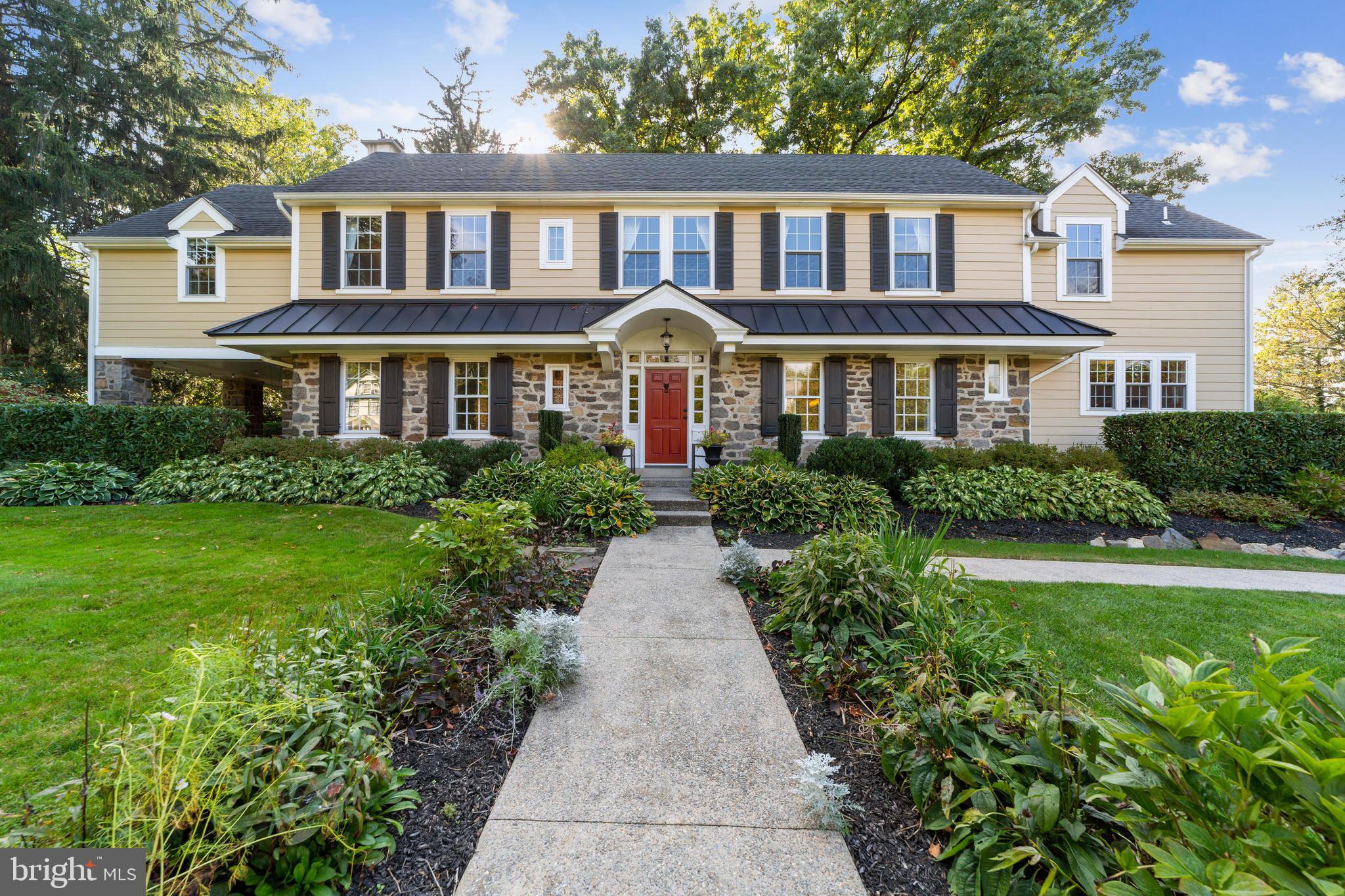 Welcome to 320 South Wayne Ave, this is the “walk to Wayne” stone colonial home you have been waiting for. Renovated and updated, this gorgeous home combines the traditional character and charm of being built in 1929 with today’s modern features and amenities. This home is truly turn-key, move in ready. The current owners extensively renovated and updated everything from roof, walls, floors, systems, electrical, plumbing, windows, to the kitchen and bathrooms. As you step up the front steps to the front walk way, you are flanked with gorgeous seasonal flowers and plantings, as well as mature landscaping around the entire house. Enter the red front door to a warm, open foyer with hardwood floors and open staircase. Powder room with tiled floor and pedestal sink and coat closet are off the foyer. The hardwood floors continue in the formal living room. This front to back room boosts windows with deep sills, 8” double crown molding, a beautiful mantle around a large brick gas fireplace and French doors out to the backyard. The traditional layout continues with a large formal dining room with crown molding, deep windowsills and hardwood floors. Custom cabinetry with glass cabinets, granite countertops and base cabinets lead into the kitchen. The gourmet kitchen is extremely functional and attractive. Custom white cabinets, granite counter tops, large island with seating, deep sink, Thermador appliances and back stairs complete the kitchen. The Thermador appliances include 6 burner oven, hot water spigot, large custom panel refrigerator, and paneled dishwasher. French doors lead off the kitchen to the family room. The room runs along the back portion of the house and has windows overlooking the gorgeous backyard. The focal point of the family room is custom built in cabinetry and mantle surrounding the gas fireplace. The gorgeous cabinetry above the fireplace store the flat screen tv. Custom cabinets with cubbies flank the side door, for plenty of storage. The room continues with an area for a table for eating, games or homework. The wet bar has custom cabinetry, a sink and beverage frig, providing more storage and options for entertaining. Doors leading out to the backyard and carport open up to the patio and side porch. The second floor offers 5 bedrooms, 3 full bathrooms, and an office. The large master bedroom has hardwood floors, crown molding, a large walk in closet, en-suite bathroom and separate office. The en-suite bathroom has handsome custom cabinetry, large stall shower with beautiful tilework. Off the master bedroom is a large office with a gas fireplace. Great space to work! Hardwood floors continue through the hallway, with a cozy nook for a desk, cedar closet, large linen closet and 4 additional bedrooms. All nice size bedrooms with good closets. The hall bath is gorgeous white tile and vanity. The 5th bedroom is ensuite with a renovated bathroom and large closet, near the backstairs. The basement has a finished laundry room and has dedicated storage area. No detail has been left unturned in this home. And it continues as you head out to the backyard. The lush, mature landscaping give this lot a private and expansive feel. The patio off the back has great space for entertaining and leads to the covered porch off the side of the house. Truly characteristic of this quintessential home is the side porch with tall stone pillars and ceiling fan. There is also a large carport that has a gas line for the gas grill, recessed lighting and electrical. A large shed offers more storage. The south wayne neighborhood offers neighborhood events, such as Porchfest, bookclub, and progressive dinners. Award winning Radnor School District. This stunning home offers it all in the coveted walk to Wayne location!! Final and best offers due Monday, Oct. 11th by2pm.