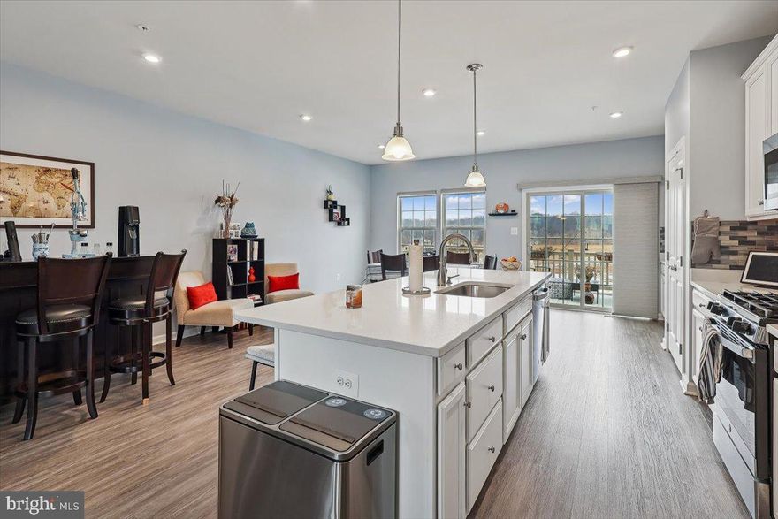 ANOTHER $10,000 PRICE REDUCTION!!  PLUS  SELLERS AGREE TO GIVE BUYER A $5000 CLOSING COST CREDIT AT SETTLEMENT!!  Truly Stunning, this spacious three level end unit townhome offers a bright modern floorplan with upgrades spread throughout 2,320 SF of elegance.  Offering three Bedrooms, two full Baths and two Powder Rooms.  The entry level features a large Recreation Room that has access to a private, fenced Patio.  This level also has a convenient Powder Room.  Step up to the second level, featuring an expansive kitchen with a large island that opens to a light filled living room.  The window lined kitchen with a glass subway backsplash provides a perfect  dining area with more natural light, that opens to a large deck with a great view, perfect for all your cookouts.  The gourmet kitchen is equipped all energy efficient stainless steel appliances, granite counter tops and lot's of cabinet storage space .  There is also a convenient Powder Room on this level.  The upper level offers three generous bedrooms, two full bathrooms and a convenient laundry area.  The Master Suite offers a tray ceiling, an oversized walk-in closet, a luxury bathroom, offering a soaking tub and a separate seated shower.  This beautiful townhome offers access to Parkside's vibrant Community amenities including a Clubhouse, Pool, Fitness Center and Playgrounds, all included in the HOA Fee.  This is a prime location,  with access to Routes 295 and 95, minutes  to Fort Meade and Arundel Mills Mall, with  friendly commuter routes to both Baltimore and WDC.