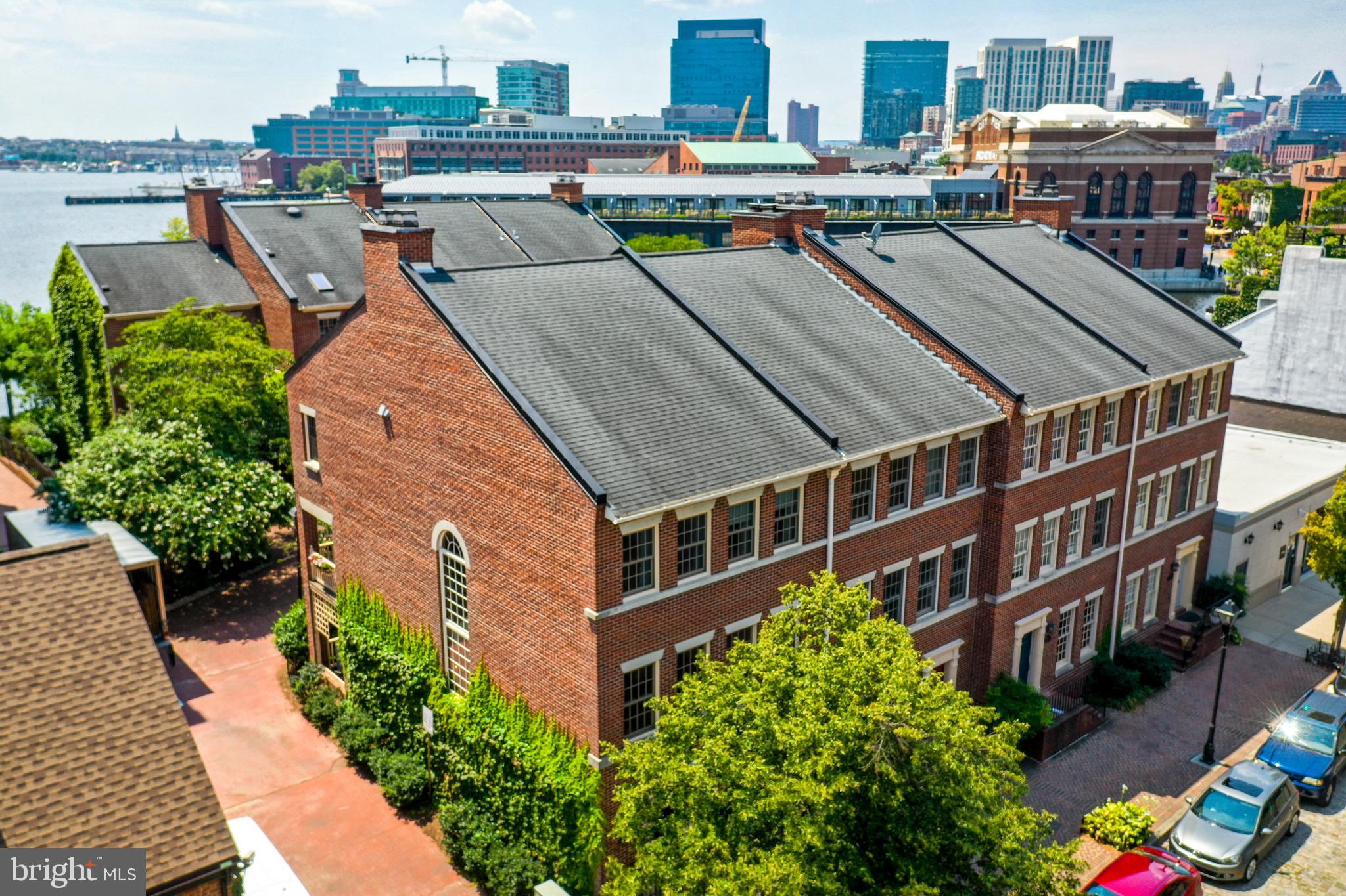 **New paint and carpet since photos were taken** Welcome to 926 Fell Street, a truly stunning residence nestled in the heart of Historic Fells Point, just steps from the waterfront and all the local hotspots right outside your door. This end-of-group rowhome boasts over 2,500 square feet of beautifully updated living space, offering 3 spacious bedrooms, 3 full bathrooms, and the rare convenience of both a private garage and driveway parking. Spread across three thoughtfully designed levels, the main entry level welcomes you with a versatile den or office space, a full bathroom, and direct access from the garage. Upstairs, the main living area shines with natural light and an open-concept layout ideal for entertaining. The gourmet kitchen features sleek quartz and stainless steel countertops, a generous island, and high-end stainless steel appliances. The adjacent dining area flows effortlessly into the sunken living room, complete with gleaming hardwood floors, a granite wood-burning fireplace, and access to a spacious covered balcony, perfect for relaxing or entertaining. The third floor is home to a luxurious primary suite, featuring a second wood burning fireplace, dual walk-in closets, and a spa-like ensuite bath with a standing shower, jetted jacuzzi tub, heated floors, and a skylight. Two additional bedrooms and a full hall bath complete the upper level. Enjoy the charm and convenience of this vibrant waterfront neighborhood, plus access to a shared courtyard and a scenic path to the harbor. Location, lifestyle, and luxury...you’ll find it all at 926 Fell Street.