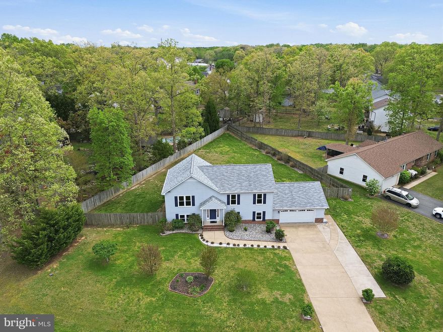Welcome home to 10507 Heather Greens Circle! This quiet oasis in Spotsylvania offers 3BR/3.5BA and ample space on a beautiful, fenced-in lot. From the moment you lay eyes on this home and the second you walk in the door, you'll feel the pride of ownership and appreciate all of the modern updates.  The refinished, natural hardwood floors on the main level are impeccable. An updated kitchen with stainless steel appliances and granite counters overlooking the massive back yard blends well into the dining space. On that same level, an updated hall bathroom, and fresh paint in both bedrooms (one with private bathroom) highlight a clean, workable floor plan. Downstairs with new LVP flooring throughout, a primary bedroom with a large walk-in closet and private bathroom provide more space and solitude. The nearby laundry room is well positioned for convenience. Boasting over 528 square feet, the recreation room with an adjacent half bathroom is one to see for yourself. Bring your biggest TV, your workout equipment, or ALL the toys and you'll still have space for more. The clean, over-sized two-car garage with workbench adds space for your vehicles, equipment, and storage. Outside, the fully fenced yard surrounds a big, flat back yard. An updated deck and fire pit with pavers give plenty of opportunity for outdoor enjoyment. The roof was replaced shortly before these owners purchased in 2022 and the HVAC system was replaced in 2023. All in all, this home is in wonderful, turn-key condition and is now ready for its next, lucky owners! Schedule your showing today!