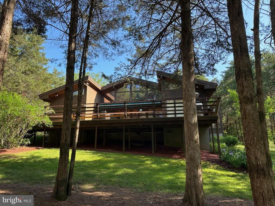 Welcome to your serene retreat near Historic Shepherdstown but with the benefit of lower Berkeley County Taxes! Nestled on a secluded lot surrounded by trees, this contemporary Lindal Cedar Home offers the perfect blend of modern comfort and natural beauty. Experience the charm you've always dreamed of!  

 As you step into this unique and well-maintained home, you're greeted by expansive windows that flood the space with natural light. The fully equipped kitchen boasts state-of-the-art appliances and opens seamlessly to an atrium-style dining area—perfect for everyday living and entertaining.

The great room impresses with its soaring, wood-clad ceilings, hardwood floors, and a stunning stone fireplace.  It flows effortlessly onto an expansive deck featuring built-in exterior seating and a retractable awning, creating a seamless indoor-outdoor living experience.  The perfect spot to hear the sounds of the babbling seasonal run that borders the property.

Designed with privacy in mind, the home offers a split-bedroom layout. The guest bedrooms are connected by a convenient Jack and Jill bath. The private primary suite, located in its own wing, features a separate entrance and dual closets that lead into a luxurious full bath with an oversized soaking tub set in its own tranquil atrium.

A cozy loft serves as a versatile family room or additional living space.   Outdoors, the property boasts multiple areas for seating, dining, and entertaining under the open sky.

Additional features include a detached two-car garage and an expansive outdoor entertaining space in a private setting. 

Don’t miss this opportunity to make this extraordinary property your own!