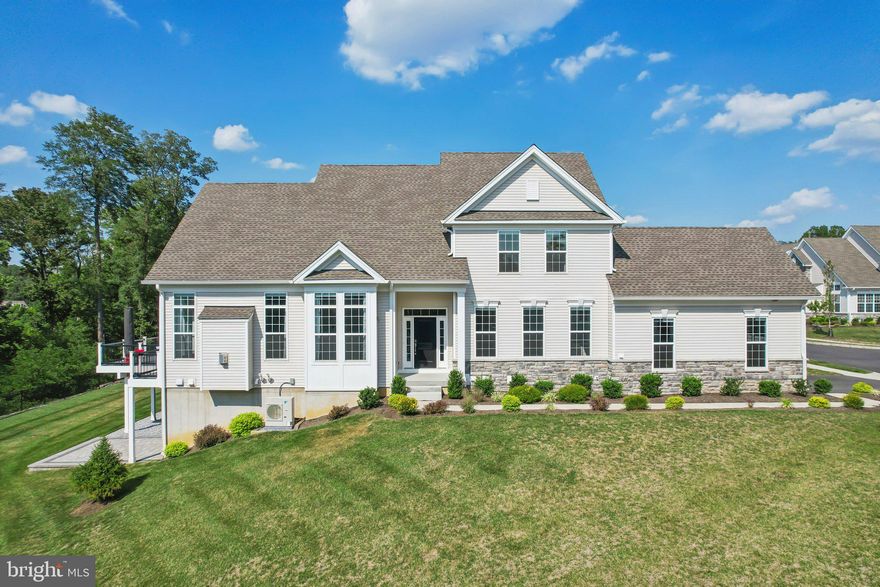 Welcome to 466 Reid Way, a very rare KINKADE model end unit carriage home by Toll Brothers in the gorgeous community of Darlington Ridge at West Chester. This spectacular home is only available due to seller relocation and is just a 5 minute drive to the growing and popular borough of West Chester, Pennsylvania. Discerning buyers will appreciate the luxurious upgrades and selections from the sleek engineered hardwood floors that span the entire first level and second floor loft, expanded floor plan on the first floor and garage, lighting upgrades, designer fixtures and finishes in the kitchen and baths, deck and patio upgrades, system upgrades and much more. You are welcomed by soaring 2-story ceilings that flow from the foyer into the living and dining rooms brimming with natural light from the floor to ceiling windows with accent transoms. The gourmet kitchen is the true focal point of this main level open to the living and dining room area and appointed with stunning quartz countertops that add a luxurious contrast and texture to the space. Additional features of this space include a multicolored tile backsplash cut on the angle, under cabinet accent lighting, a massive center island with additional seating and storage, custom off-white Century Chatroom Cabinetry and a Kitchenaid stainless steel appliance suite that includes a 5-burner cooktop and wall oven with microwave combo (minus refrigerator). It is easy access out to a large low-maintenance expanded deck surrounded by black decorative rails overlooking walk out basement custom paver patio made to entertain easily inside and out! Enjoy the luxury of main level living with a first floor owners suite complete with a tall tray ceiling, dual walk-in fully equipped closets, a linen closet, and serene en suite bath appointed with high end selections, a glass shower surround with a wide bench seat, dual vanity and water closet for privacy. The first level is finished with a large home office with glass French doors, sun-filled laundry room, mud room and powder room. Ascend the curved staircase to an expanded, open and airy loft space with more engineered hardwoods. Two large bedrooms and two full baths complete the second level. Bedroom one features an en-suite full upgraded bath. Bedroom two boasts a tall cathedral ceiling and shares a loft accessible full bath with a subway tile tub shower combo. This upgraded and expanded Kinkade floor plan is ONLY available in end unit home sites. This home is the definition of a move-in ready and lifestyle equipped with all the upgraded features like motorized electric blinds to all windows, including the garage, that can be centrally connected to Apple Homekit as well as decorator rods on all windows, full home ethernet cabling for all TV's upstairs and downstairs and loft, pre cabling for EV charger in garage, generator equipped electrical panel and much more all on a premium $50k lot. This owner has added the expanded deck, paver patio, on demand hot water system and replaced the original HVAC system with an upgraded Daikin HVAC complete with heat recovery air recycling system. The HVAC system provides 2 zones with an optional 3rd zone in the basement. 466 Reid Way is conveniently located in West Chester, known for its vibrant community, excellent schools, and numerous amenities. Residents will appreciate the proximity to local parks, shopping centers, restaurants, rich history and entertainment options. The area also offers easy access to major highways, making commuting a breeze. Don't miss the opportunity to get the one of the BEST end unit homes in Darlington Ridge.