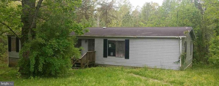 AMAZING investment opportunity!  Three bedroom two bath manufactured home built in 1989 located on nearly 3 acres on a cul-de-sac just 2 miles East of I-95 in rapidly growing Ruther Glen.  Value is in the land, offering two separate lots, sharing a line (69-A-22A + 69-A-23) totaling nearly 3 acres.  Because the lots are adjacent, land can be redistributed equally between the two if the owner wants to. The house is currently uninhabitable, there  is significant water damage to the floor please do not enter.  Being sold as is. House may or may not be salvageable.