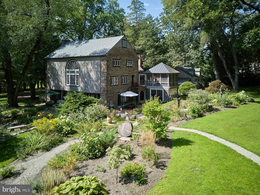Wolf Hall is nestled on over 6 park-like acres of serene and private land that continues all the way to the very banks of the Delaware River. This 1875 converted barn offers a perfect blend of historic charm and modern luxury. The main house, characterized by its stone-exposed walls, beamed ceilings, and intact historic appointments, is bathed in natural light throughout creating an inviting atmosphere that connects you to the picturesque riverfront setting. The heart of the home is the massive great room, with beamed ceiling, handsome brick floors, and wood stove. This room is a desirable setting perfect for displaying art, enjoying cozy seating areas, all while surrounded by verdant garden views. It’s perfect for entertaining or quiet reflection, and its open floor plan allows for a variety of decorating and furnishing ideas. A newly renovated modern and streamlined kitchen with quartz counter tops and stone-exposed walls creates an effortless space that flows through to a stunning breakfast room flooded with sunlight. Sliding doors lead to twin brick laid patios, garden paths, and many outdoor activities. Additionally, the first floor has a large office or flex space with a separate entrance. Indulge in the private spa, complete with resistance pool, hot tub, radiant heated floors, sauna, and a full bath. The second level is equally impressive, housing the main bedroom suite. This personal haven boasts a fireplace, private deck, and stunning river views. The luxurious spa bath and enormous walk-in closet add to the suite’s exclusivity. Additionally, there are four more bedrooms, a full bathroom, as well as a magnificent library with built-in bookcases, a Palladian window, a stunning room with vaulted beamed ceilings, a wood stove, a dry bar, a separate entrance with spiral staircase down to the garden, a second kitchen, laundry, powder room, and a fabulous screened-in porch with magnificent river views. Further enhancing this property is a detached completely renovated one-bedroom apartment, with large bedroom, bath, laundry and kitchenette. The outdoor space is equally enchanting, featuring a large in-ground pool and pool house. An additional enchanting retreat, perched with stunning views is a refuge for art, yoga, or meditation. This building is equipped with electricity, water, and features a stone wood burning fireplace. Completing this extraordinary property is a three-car garage with electric chargers and ample space for vehicle storage. There is also a greenhouse for the hobby gardener. The estate is fully fenced, offering both privacy and security. This converted barn, on the National Historic Register is more than just a home; it’s a peaceful sanctuary blending historical elegance with modern amenities, all set against the backdrop of an unforgettable park-like setting with riverfront vistas. A rare find on the Delaware River!