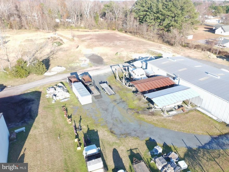 Marine or Contractor Ready Industrial Property on 3.25± Acres – Versatile Facility with Office/Apt Space

Exceptional opportunity to own a well-equipped industrial property situated on 3.25± acres. The main structure features a 50’ x 100’ steel-framed, fully insulated and heated building with three-phase power and a heavy-duty 6”–8” reinforced concrete floor, ideal for accommodating a wide range of commercial or industrial operations.

The warehouse offers 15’–16’ ceiling height and is outfitted with four 14’ x 12’ roll-up doors, providing excellent access for equipment, vehicles, or material handling, with potential to add a fifth door on the end wall for expanded functionality.

Inside the building, you’ll find an enclosed workspace/office complete with its own split-unit HVAC system, allowing for dedicated climate-controlled operations or administrative use.

Attached to the main structure is a 20’ x 60’ conditioned office/apartment space, featuring central HVAC, full kitchen appliances, and comfortable living or office accommodations. This area includes one full bath and one half bath, along with a mix of tile, carpet, and vinyl flooring. A concrete crawlspace beneath the office/apartment adds utility and accessibility.

Finally, there is two separate steel over hangs in the rear measuring roughly 20'x404'.  Ideal for outside work/storage.

The property is serviced by well water and county sewer, offering a practical and cost-efficient infrastructure setup.

This versatile industrial property is well-suited for contractors, marine businesses, storage, light manufacturing, or mixed-use operations combining workspace and on-site living or office needs.