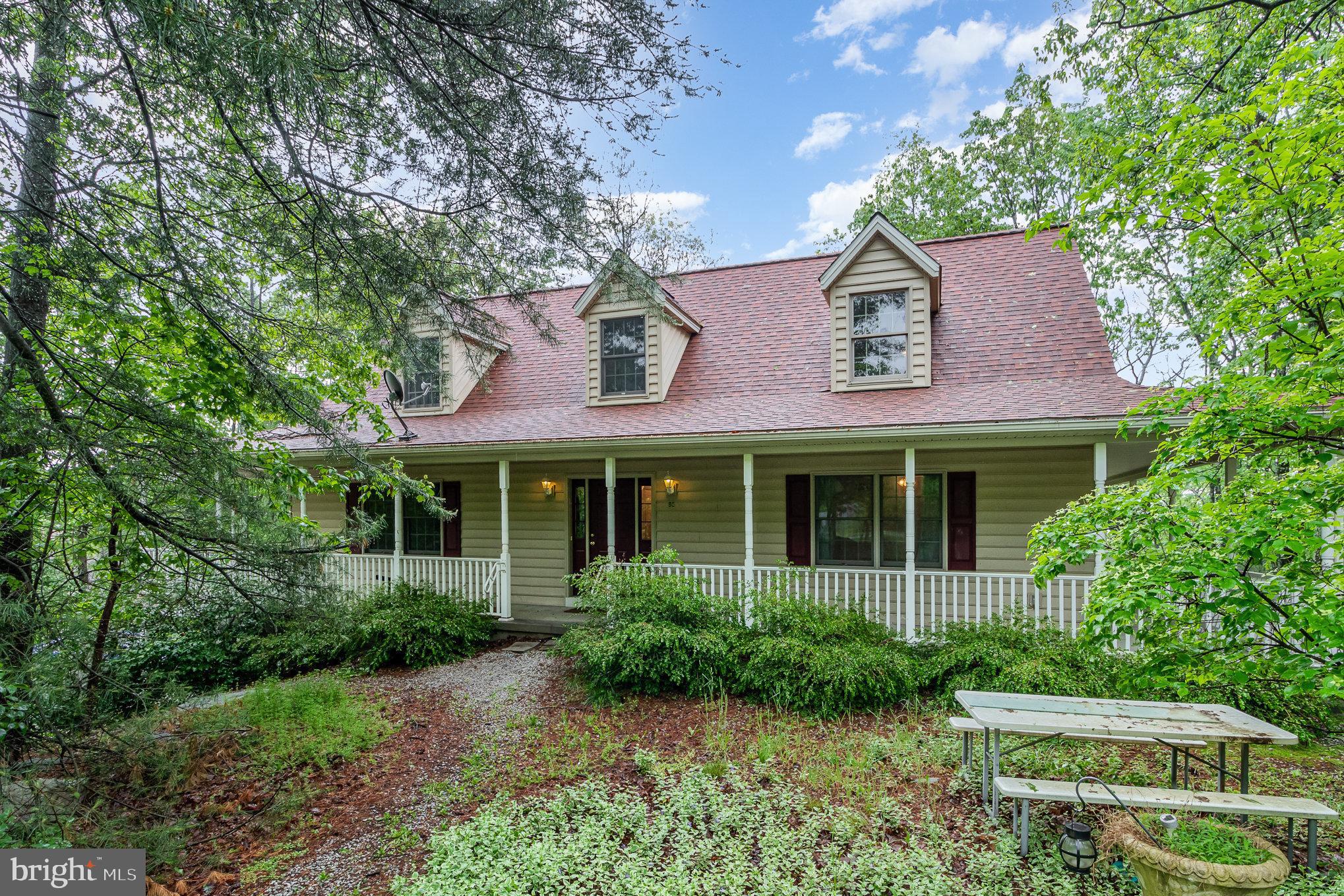 Discover the charm of this stunning Cape Cod home, complete with a welcoming wraparound porch. This inviting property features 3 spacious bedrooms and 2.5 baths, including a convenient first-floor primary bedroom. The kitchen is complimented with a propane stove that provides a cozy warmth to take in the beautiful Mountain View’s. Enjoy fresh carpeting coupled with a fresh, professional cleaning. This properly offers the convenience of both a 2-car integral garage and a separate 2-car detached garage. With breathtaking views and tranquil seclusion, this home is the perfect retreat you’ve been seeking. An additional 1.68 acres, 55 Scarlet Way, can be purchased separately.