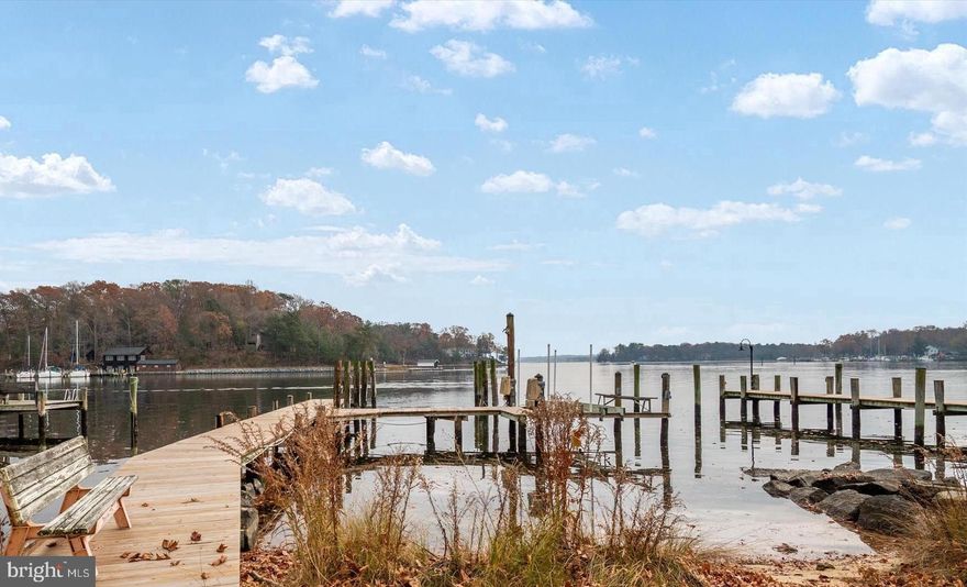 Wake up to expansive views of the Magothy River from this completely renovated Coastal Cottage in the Severna Park community of Magothy Beach!    Deep water (8' +MLW) with boat lift on updated pier,   Step inside to discover the water views from both levels,   Open layout offers a great room with gas fireplace for the upcoming chilly weather, a chef's dream kitchen with abundance of cabinetry, quartz countertop, tiled backsplash & deluxe s/s appliances including 5 burner gas stove and 9' island for ample seating plus separate dining room with custom lighting,  Sliders lead to waterside deck  for relaxing while taking in the tranquil view, that steps down to custom patio for additional dining/grilling & entertaining space, Two bedrooms with custom details and two luxuriant bathrooms with tiled showers/baths , HVAC is electric with propane gas backup (1 yr), Architectural roof (1 yr), Windows & doors (1) LPV throughout  with exception of custom-tiled bathrooms , Lower level boasts an oversized family room  for additional gathering and entertaining space, a bar/entertaining area and half bath (with RI full bath connection should you wish to reconvert back to full bath).   Ample storage in the unfinished portion of LL as well as two outdoor storage outbuildings including a shed and waterside storage for your toys or equipment, Lawn sprinklers on waterfront side, Public water/sewer, Severna Park school district, Flood insurance not required, HOA paid as part of taxes