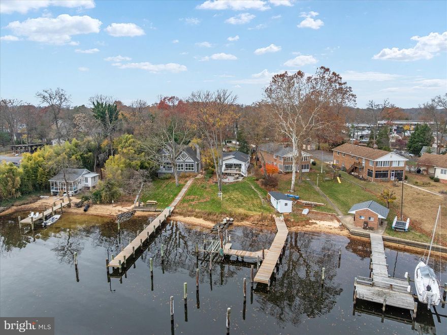 Wake up to expansive views of the Magothy River from this completely renovated Coastal Cottage in the Severna Park community of Magothy Beach!    Deep water (8' +MLW) with boat lift on updated pier,   Step inside to discover the water views from both levels,   Open layout offers a great room with gas fireplace for the upcoming chilly weather, a chef's dream kitchen with abundance of cabinetry, quartz countertop, tiled backsplash & deluxe s/s appliances including 5 burner gas stove and 9' island for ample seating plus separate dining room with custom lighting,  Sliders lead to waterside deck  for relaxing while taking in the tranquil view, that steps down to custom patio for additional dining/grilling & entertaining space, Two bedrooms with custom details and two luxuriant bathrooms with tiled showers/baths , HVAC is electric with propane gas backup (1 yr), Architectural roof (1 yr), Windows & doors (1) LPV throughout  with exception of custom-tiled bathrooms , Lower level boasts an oversized family room  for additional gathering and entertaining space, a bar/entertaining area and half bath (with RI full bath connection should you wish to reconvert back to full bath).   Ample storage in the unfinished portion of LL as well as two outdoor storage outbuildings including a shed and waterside storage for your toys or equipment, Lawn sprinklers on waterfront side, Public water/sewer, Severna Park school district, Flood insurance not required, HOA paid as part of taxes