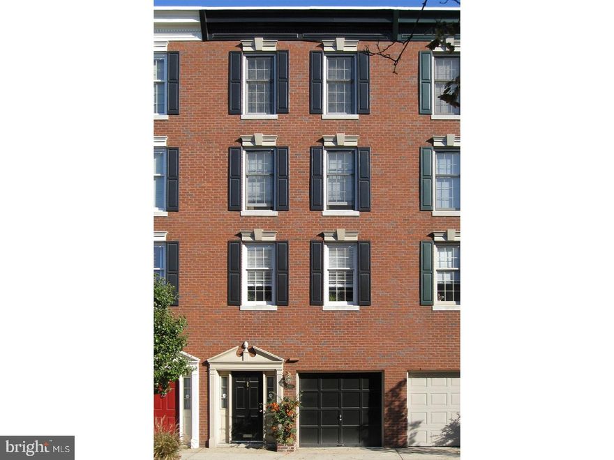 Grace and elegance converge with comfort and functionality in this impeccably maintained 4 bedroom, 3.5 bath town home in Rittenhouse. Built by Kostas Macos, this 3,071 sq ft abode is 4 stories and offers a garage, private garden, and a breathtaking roof deck!  Enter a marble foyer that extends into a laundry room, half bath, and spacious storage closet. An adjacent den boasts custom built-in bookshelves and cabinetry, bamboo flooring, and a door that opens to the beautiful garden. Upstairs, the kitchen is drenched in sunlight and features tall cabinetry, custom built ins, ample granite countertops, a wine cooler, and a JennAir gas stove with down draft. A beautiful doorway leads to the formal dining room with exquisite dentil moldings. In the living room, sophistication meets relaxation with soaring 10 ft ceilings, French doors leading to two juliet balconies, moldings, a wood burning fireplace, and built-in speakers. On the third floor, you'll find two bedrooms, one of which has a spacious en-suite bath and walk-in closet. On the fourth floor, the master bedroom is highlighted with moldings and a walk-in closet. The adjoining master bathroom has a luxurious walk-in shower with frameless door, double sink with zodiac top, built-in vanity, tile floor, and two large medicine cabinets. An additional, fourth floor bedroom is drenched in natural light and has a large closet. Lastly, this level offers a wetbar and stairs leading to the roof deck with unobstructed views of the Center City Skyline! Enjoy city living at its finest with everything at your fingertips.