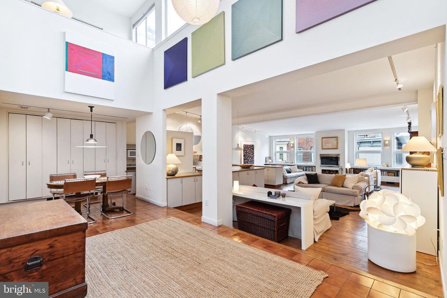 Historic double-wide Carriage House with GARAGE Parking, nestled on one of the Art Museum area’s most coveted tree-lined blocks. Architect restoration in the 1980s has created a unique loft-like live/work space. Enter the first floor artist's residence through a private entrance on Brandywine Street, you will be welcomed by a reception area leading into a working artists’ studio space with a fully equipped kitchen and bathroom. 

One floor up from the street, you'll find the sunny main living space which boasts a soaring double-height atrium and almost 2,000 square feet of uninterrupted space. The contemporary open plan living area is ideal for hosting guests and showcasing an extensive art collection, anchored by a wood burning fireplace flanked by custom built-ins and a suite of four south-facing windows spanning the spectacular 30’+ wide space. Custom cabinetry in the kitchen provides generous storage space and wraps around an oversized island with granite tile counter tops, illuminated by industrial pendant lights. The adjacent dining room is part of the tiled atrium and provides extra space for entertaining and a wall of closets with additional storage. Completing the second floor is the primary bedroom, which overlooks quiet Brandywine St and features an ensuite bath with a luxurious soaking tub, walk-in closet, and an additional hallway bathroom with a stall shower. 

Ascend the stairs along an exposed brick wall to the third floor where a sun-washed loft space provides additional space for a sitting room or study. Three large south-facing windows overlook the roof deck with sweeping city views. Across the hall is a spacious second bedroom with ample closet space, treetop views and an ensuite bath. 

Tucked away in one of the city's most convenient neighborhoods, this exceptional property is just steps from Fairmount Park, The Barnes Foundation, Whole Foods and a variety of great restaurants including Tela’s Market & Kitchen, Umai Umai, and Bar Hygge.  This is the perfect home for those seeking a unique blend of history, character, and modern amenities.