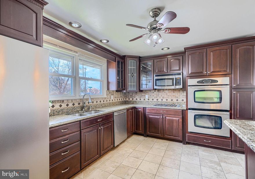 4-bedroom rancher conveniently located in the highly desirable Rosedale community! This well-maintained home offers the ease of one-level living with beautiful hardwood floors throughout the main level. The spacious, extra-large kitchen is a true highlight, featuring stainless steel appliances, a large island, and abundant counter and cabinet space—perfect for cooking and entertaining.
The main level includes three generously sized bedrooms and a beautifully updated full bathroom with a walk-in shower. The fully finished basement spans the entire length of the home, providing incredible additional living space with a large recreation area, a fourth bedroom, and a second full bathroom—ideal for guests or extended living. Step outside to enjoy a wonderful outdoor setting with a covered back patio and a spacious backyard, offering plenty of room for relaxation or gatherings. For added convenience, a covered carport is located just off the kitchen.