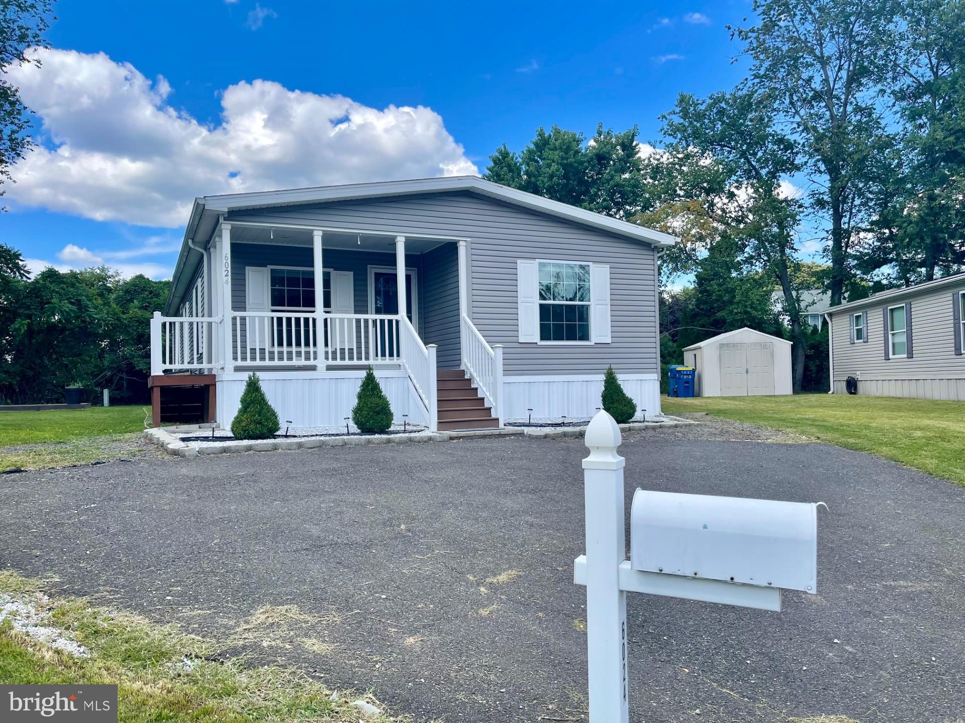 Welcome to this beautifully renovated gem in Pennwood Crossing, nestled in the heart of Morrisville, PA—a town rich in history and full of small-town charm. Built in 2016 and set on one of the largest lots in the community, this move-in-ready home offers the perfect blend of modern comfort and timeless appeal.
Step inside to a bright, open concept living space featuring a cozy fireplace and seamless flow into a recently remodeled kitchen and dining area. The kitchen boasts ample pantry storage and a convenient adjoining laundry room. The primary suite is a peaceful retreat with a full private bath and a generous walk-in closet. Two additional bedrooms and a second full bath provide plenty of space for family or guests. Enjoy your morning coffee on the inviting covered front porch and take advantage of the spacious driveway with ample parking. With newly updated flooring throughout, this home is designed for easy living and effortless style. Why Morrisville? Located along the scenic Delaware River in Bucks County, Morrisville offers a unique blend of historic charm and modern convenience. Just minutes from Philadelphia and Trenton, it’s perfect for commuters and those who love being close to city life while enjoying a quieter suburban atmosphere. Explore local favorites like the Delaware Canal State Park, Williamson Park, and charming coffee shops and eateries. The area is known for its strong sense of community, excellent schools, and vibrant local events like the Morrisville Carnival and Winter Wonderland Parade. Affordably priced and ready for you to move in and enjoy, this home is more than just a place to live—it’s a lifestyle. Lot rent includes water usage, snow removal, and trash service (please confirm with the association). Don’t miss your chance to own a piece of Morrisville’s charm—schedule your showing today!