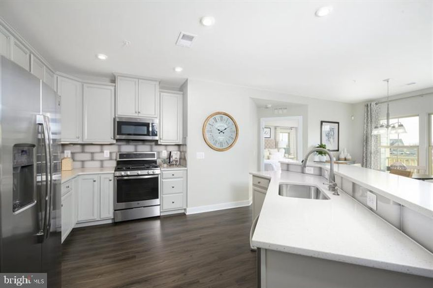 Welcome to Urbana's only EXCLUSIVE 55+ active adult elevator condo's community!  This to be built Chambord at the Woodlands by Ryan Homes.  Embrace the convenience of a condo with all the comforts of home! Enjoy your own private 1 car garage & driveway, 1-level living with open design, gourmet kitchen w/ 2-tier island, private covered porch, panoramic views in primary suite, and so much more! Built with upgraded 5 inch  engineered hardwood, luxury tile, granite in kitchen and both baths,  42 inch kitchen cabinets. Community features endless amenities   truly resort-style living!  Other floor plans and homesites are available. Photos are representative.