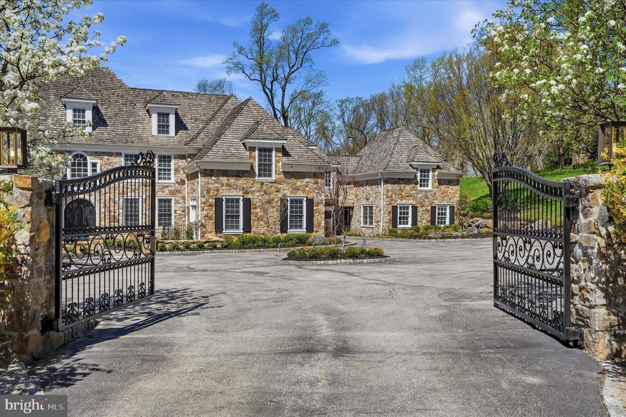 A Breathtaking Stone Villanova Estate 
7 BD  |  7 BA  |  2 Half BA  |  4.33 Acres  |  Private Road  |  3-Car Garage
Set on 4.33 acres, this property commands the quiet authority of a true Main Line estate. Impeccably reimagined for today's most discerning buyer, this fully renovated home elevates every one of its 10,000 plus square feet to the highest standard. Sequestered behind estate fencing along a private road, this magnificent stone residence stands as a testament to refined living and thoughtful modern vision.
Seven stylish, generously proportioned bedrooms, 7 breathtaking full bathrooms, and 2 beautifully appointed powder rooms offer gracious accommodations for all, with unmatched attention to detail and quality throughout.
Main Level: 
Enter through estate fencing onto a circular driveway leading to a classic stone exterior with cedar shake roof.  Grand double doors open to a two-story, sun filled grand foyer featuring a custom staircase with designer railings and wide plank hardwood flooring that flows throughout. A dedicated greeting area with seating sets the tone from the moment guests arrive. Off the foyer, a large professional home office is designed for today's executive. The formal living room is anchored by one of 3 custom marble fireplaces, while the large formal dining room overlooks the grounds. A dedicated wine closet adds a refined touch for the collector or host. The large 1st floor in-law suite features a private balcony/entrance, walk-in closet, and custom bathroom. The primary kitchen, just off the dining room, is outfitted with professional stainless steel appliances, custom range hood, waterfall marble island with seating, tile backsplash and under cabinet lighting. The catering kitchen, just off of the main, offers professional grade appliances, granite countertops, under cabinet lighting, and tile backsplash that mirrors the quality of the primary kitchen. The breakfast room features custom bench seating with views into the amazing two-story family room, complete with built in lighted shelving, custom chandelier, and panoramic views of the grounds. Rounding out the first level is a designer powder room, a dedicated dog grooming suite with shower and individual pet sleeping quarters, one of three laundry areas, and a pantry/package room.
2ND Level:
The 2nd level's unparalleled primary suite features a sitting area with marble fireplace, walk-in closet/dressing room, and a spa-like bathroom with his-and-her vanities, freestanding tub, towel warmer, and a floor to ceiling oversized marble steam shower. Three additional bedroom suites, a 2nd laundry area, and access to the guest houses' 2nd floor complete this level. 
3RD Level:
The 3rd Level is an apartment sized private retreat with bedroom, sitting areas, loft and full bathroom.
Lower Level:
The walk-out light filled lower level features a home theater with comfort seating, snack area, gym, salon with shampoo and barber chair, full wet bar with ice maker, refrigerator, and wine cooler, lounge/game area, plus an exquisite full bathroom and plenty of additional storage. 
Guest House:
The two-story guest house, with private entrance, provides a true independent living space with full kitchen, living room,  eat-in kitchen counter and 1st floor powder room.  The 2nd floor of the guest house features a bedroom, seating area, and full bathroom. 
This is not simply a home, it’s an exquisite, one-of-a-kind breathtaking Main Line estate that leaves nothing left to be desired.  This estate is in absolute move-in condition and is newly, and fully, renovated!  Far too many specialized features to list. A MUST SEE!  This is your rare opportunity to own a property of this caliber in the prestigious estate section of Villanova, where legacy properties of this character, scale and acreage seldom reach the market.  
Please present buyers qualification/BFI for showing approvals. Minimum 24 hr notice for showings.