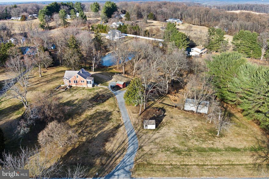 What if your dream home overlooked a massive, private pond entirely within your own property? What if it came with multiple outbuildings limited only by your imagination—including original farm structures, a huge metal Quonset style barn and smaller sheds-  plus fenced garden areas and paddock spaces ready for goats, chickens, hobbies or homestead dreams?

Imagine no further. 11850 Ramsburg Road in Marriottsville is coming to market for only the second time in its 100+ year history. Rare large parcels like this seldom appear—and especially not at this exceptional value. 

This charming 1,774 sq ft home features high ceilings, original period details throughout, a full-height unfinished basement for endless potential, and baseboard oil heat. Original hardwood flooring is found throughout, and the covered front porch is asking for you to pull up a rocker and enjoy the sunset. 

Recent updates include relocating the laundry from the basement to the smaller main-level bedroom next to the kitchen, and transforming the larger front bedroom into a bright, colorful craft space. Upstairs, two decent sized bedrooms are found along with ample storage and room to convert the existing half bath into a full bath for added convenience. 

And all of this plus close proximity to Marriotts Ridge HS, Mount View Middle, MD Rt 32, Interstate 70 and minutes from Sykesville and Ellicott City's charming historic districts.

Embrace your inner Green Acres vision in Marriottsville—whether farming, gardening, creating, or simply enjoying the serenity. Sold strictly as-is, this is your chance to bring your designs and dreams to life on a one-of-a-kind property. Ready to make it yours?