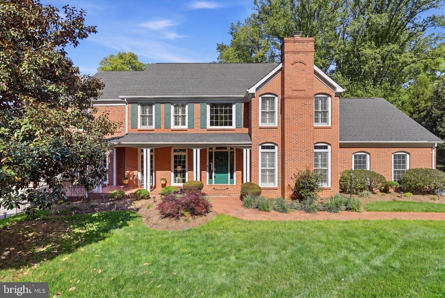 Impressive brick home, with OVER 5,400 square feet of living space, is nestled on a spacious 0.68-acre lot in a prime Annandale location is ready welcome you home! FEATURES include - No HOA, Woodson HS pyramid, close proximity to parks and trails, dedicated space to operate a small business, second 2-car garage with lift perfect for the collector, and flexibility for multi-generations to live.   DISCOVER 5 bedrooms, 4 full baths, and 1 half bath, plus an extraordinary addition featuring a main floor flex room (perfect for a main floor bedroom), second garage and workshop; this home offers sophisticated design with everyday functionality. A CHARMING brick walkway leads to the inviting wraparound front porch, setting the tone for the timeless appeal found throughout. Inside, a DRAMATIC two-story foyer with rich hardwood flooring, a sweeping staircase, and a chic chandelier creates a stunning first impression. The main level offers an EXCITING blend of formal and casual living spaces, including a home office, elegant living and dining rooms, and an updated kitchen outfitted with stainless-steel appliances and granite countertops. The kitchen opens to the COZY family room with a gas fireplace and a light-filled sunroom with walls of windows and skylights. Step outside to the Trex deck and fenced backyard for easy indoor-outdoor gatherings. A SPACIOUS flex room and large laundry room, accessible via French doors from the living room, could easily be transformed into a main-level bedroom suite. A mudroom with built-ins and utility sink, along with a convenient half bath, complete the main level. Upstairs, the primary suite is a private RETREAT, featuring its own fireplace, generous walk-in closets, and a bright spa-inspired bath with skylight, soaking tub, and walk-in shower. Each additional bedroom offers unique character—discover a room with an en-suite bath with stylish barn door, a bedroom with a custom mural sure to delight, and a bedroom with a charming loft with built-ins.  All 4 secondary bedrooms include ample closet space and beautiful wood shutters. The walk-out lower level expands the home’s VERSATILITY with a spacious recreation room with built-in media center, full bath, and abundant storage. A standout feature is the climate-controlled WORKSHOP with its own loft; perfect for hobbies, home business or creative pursuits.  Car enthusiasts and hobbyists will especially appreciate the additional attached 2-car garage, complete with a car lift, EV charging outlet, and substantial loft storage.  Ideally located with quick access to I-395, this home offers EXCEPTIONAL convenience to shopping, dining, parks, bike paths, and everyday amenities while still providing a sense of space and privacy.  A rare opportunity to own an inviting yet DISTINCTIVE and thoughtfully appointed home designed for the way you live today.