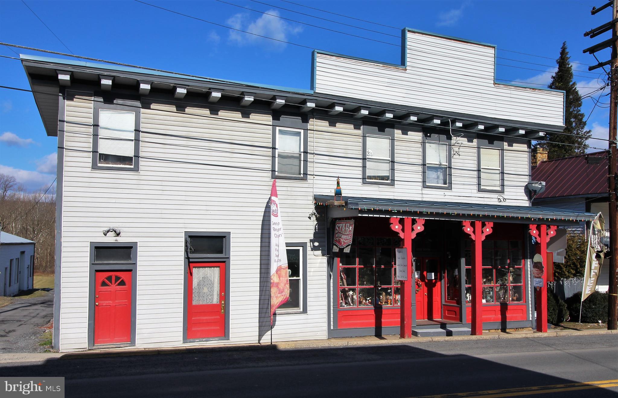 WARDENSVILLE: Perfect business opportunity! In the heart of one of the fastest growing towns in the Great State of West Virginia, you will find this rare gem. A building with "character", charm and an interesting past. The main room has an exceptionally high ceiling covered in the original decorative tin from the early 1900's and a mural painted by a local artist from the 1970's. This diversified property allows for multiple opportunities to increase its income potential. In the past the ground floor has been a restaurant and unique gift shop. The second floor contains four occupied apartments that provide a steady income, There are additional areas for office space or other income-producing activities. Large deck for outdoor seating and entertainment, parking area for tenants, separate storage building, and a grand view of the river that runs along the back border of this approximate 1/2 acre of prime real estate.