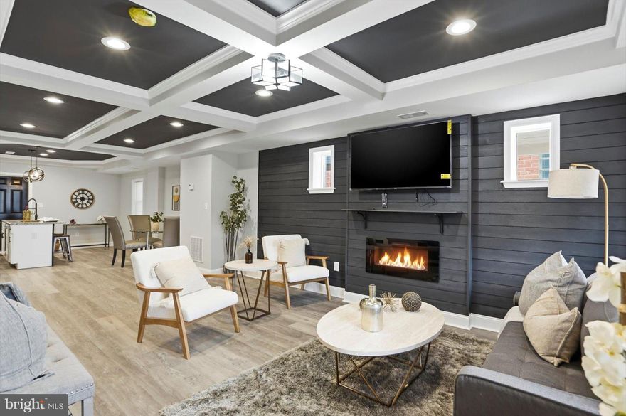 A stunning transformation has taken place behind the door of this 4BR/2.5BA end of row Townhome located in the quiet neighborhood of Berea.   Make your way to the covered front porch past the gated front yard, and open the door into your dream home.  Step into a home filled with natural light, recessed lighting, luxury flooring, and tons of custom features.  The main floor features an open floor plan boasting custom coffered ceilings throughout the large living room featuring custom feature wall with a fireplace feature, a spacious dining area, a half bath behind a custom barn door, and a stunning kitchen.  The kitchen features plenty of cabinets, stainless steel appliances, subway tiled backsplash, and a stainless sink set into an island with breakfast seating and pendant lights.  On the second floor are two sizable secondary bedrooms, a larger primary bedroom with a walk-in closet, and a newly remodeled full bath with tile from ceiling to tub.  On the lower level is the fourth room that can be used as a bedroom or flex space, a new full bath, laundry, storage, a large recreation room with a fireplace feature, and a walk-out to Bilco doors in the newly fenced yard.  From the kitchen, step outside to a large covered patio, plenty of green space, and a large parking pad for two cars.  This home is move-in ready, ideal for any new homeowner, and is located in close proximity to shopping, restaurants, and commuter routes.