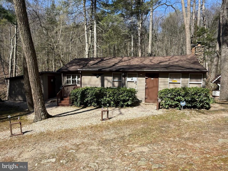Welcome to Eagles Nest, a rare opportunity to own a secluded cabin tucked deep within the breathtaking Michaux State Forest. Surrounded by nature and offering unmatched privacy, this property sits on leased state forest land—an exclusive setting where only a handful  of cabins are permitted.
This meticulously maintained 2-bedroom cabin offers 1,032 square feet of warm and inviting living space. Inside, you’ll find spacious gathering and sitting areas perfect for relaxing or entertaining, a full kitchen, and the charm of both a wood stove and a stunning stone propane fireplace—ideal for cozy evenings year-round.
Step outside and take in the peaceful setting, where a gentle stream runs alongside the property, creating the perfect backdrop for quiet mornings and evenings by the fire. The property also features a 12x12 shed for additional storage and a gated driveway for added privacy and security.  The property has a well maintained heated outhouse.  All of the cabins contents and furniture is included in the sale price and is to convey.  This is truly a move in ready cabin with everything you need to enjoy the upcoming summer.
Eagles Nest is truly a nature lover’s retreat, with abundant wildlife and endless opportunities for outdoor recreation right at your doorstep.  Within the forest there are miles of trails, lakes, a pool, golf courses and so much more.  Whether you’re looking for a private family getaway, a hunting cabin, or a place to unplug and recharge, this one-of-a-kind property delivers.
Don’t miss your chance to own this cabin in the Michaux forest—properties like this rarely become available.

   *This is a land lease and cannot be a primary residence. Buyer must be a PA resident, and this is a cash only sale*