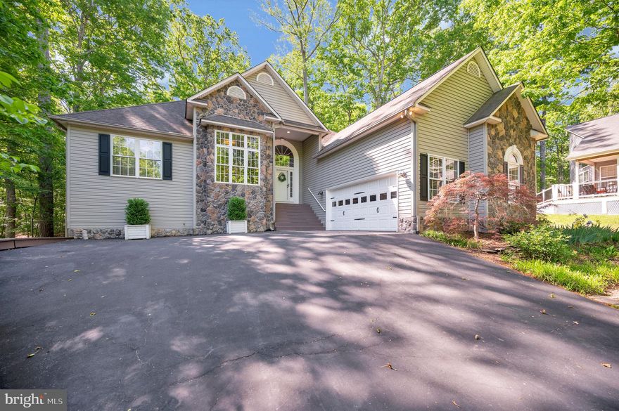 Welcome home to 801 Eastover Parkway in the beautiful Lake of the Woods community — where comfort, charm, and peaceful wooded views come together in all the right ways. Tucked against a backdrop of trees for added privacy, this 3-bedroom, 3-bathroom home invites you in with warmth from the very first step inside.

As you enter, soaring cathedral ceilings and rich hardwood flooring create an airy, inviting atmosphere throughout the main living area. The gas fireplace adds the perfect cozy touch, making the space feel both grand and welcoming at the same time. Just beyond, the kitchen and dining area are thoughtfully tucked away, offering the perfect setting for quiet mornings or lively gatherings. The dining room’s sliding glass door opens to a carpeted sunroom — an ideal spot to sip coffee, unwind with a book, or simply enjoy the peaceful surroundings — with additional access to the deck for easy outdoor living.

The kitchen shines with recessed lighting, crisp white cabinetry accented in black, and stainless steel appliances that give the space a timeless yet modern feel.

Retreat to the spacious primary suite featuring hardwood flooring and a spa-inspired bathroom complete with LVP flooring, dual sinks, a soaking tub, walk-in stand-up shower, and an oversized walk-in closet ready to handle every season of storage.

Downstairs, the finished basement expands the living space with endless possibilities. Featuring LVP flooring, another cozy fireplace, a large living area, an additional bedroom, full bathroom, and extra storage space tucked away in the back, this lower level is ready for guests, hobbies, movie nights, or simply spreading out and enjoying home.

Complete with a two-car garage featuring a workbench and storage areas, this home blends comfort, functionality, and inviting character in a peaceful wooded setting.

Nestled in a private, secure, gated community, Lake of the Woods is a paradise of possibilities. With two lakes, a golf course, an equestrian center, fire and rescue services, and even a church within its bounds, this community offers a diverse range of activities. From boating, water skiing, kayaking, and golfing to the simple joy of soaking in mesmerizing views from the clubhouse, deck, yard, or beaches, there's something for everyone. Engage your interests by joining over 60 clubs and organizations, or perhaps indulge in a game of bridge or contribute your talents as a volunteer. Lake of the Woods truly caters to your lifestyle.

Located in Orange County, enjoy the added advantage of low real estate taxes. With home prices spanning from $300,000+ to over $2,000,000, Lake of the Woods is the ideal haven for both full-time residents and weekenders. Don't just take my word for it – come and see for yourself! Allow me to guide you through a tour of Lake of the Woods, showcasing the very essence of what makes this community so special. Experience firsthand the captivating charm of Lake of the Woods!