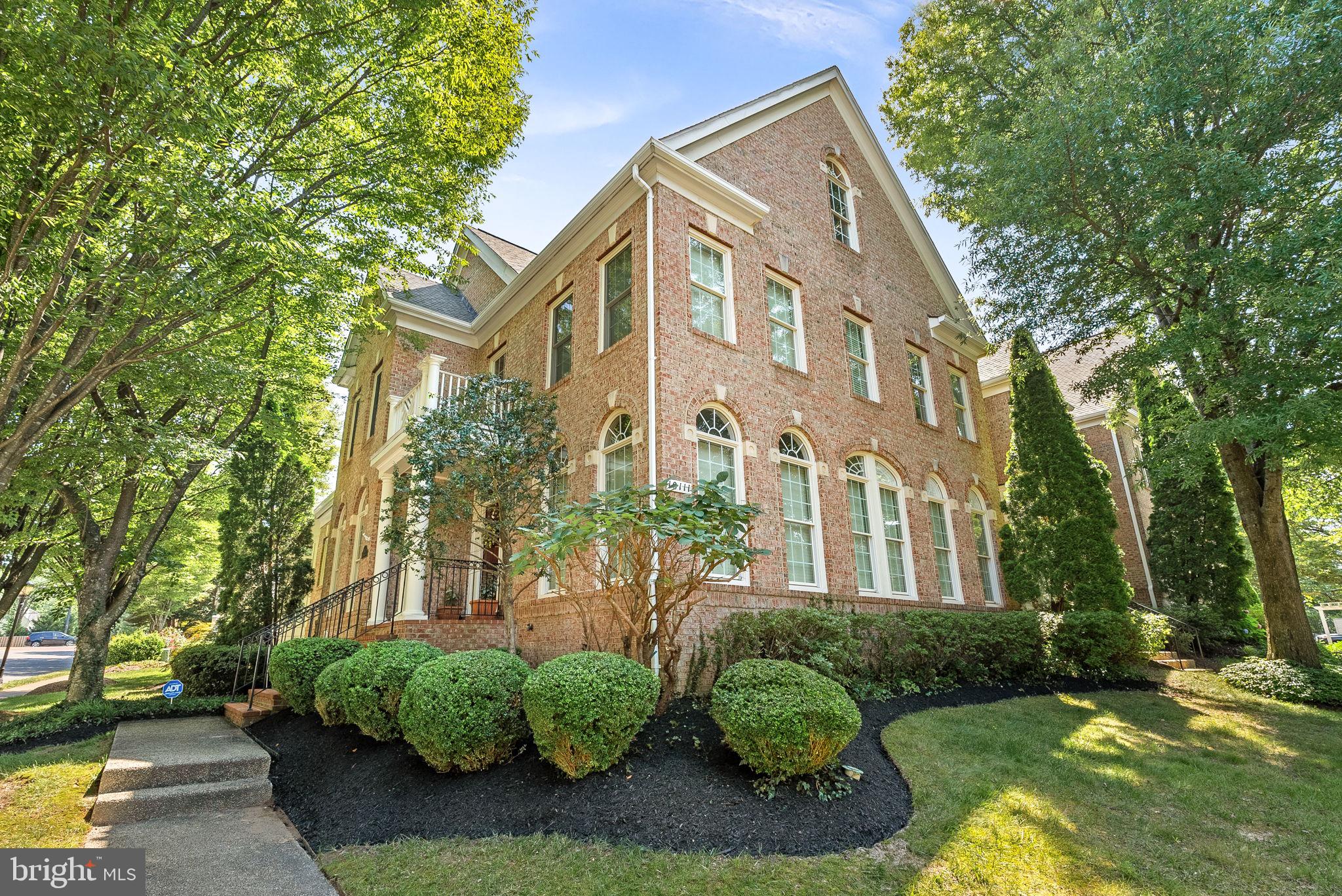 Rarely available end-unit courtyard townhome in the prestigious Farrcroft community, now offered with an incredible price adjustment! offering a main-level primary suite and elegant design throughout. This beautifully maintained home features hardwood floors on the main and upper levels, extensive trim work, plantation shutters, and oversized windows that fill the space with natural light. The updated kitchen (2022) showcases white cabinetry, quartz countertops, a central island with seating, and newer stainless steel appliances. The spacious family room with gas fireplace opens to a private walled patio—perfect for relaxing or entertaining. The main-level primary suite includes two walk-in closets, custom built-ins, and a luxurious bath with heated floors, a seamless glass shower with multiple showerheads, and a designated drying area. Upstairs includes three additional bedrooms (one en-suite), all with walk-in closets and hardwood flooring. The finished basement (2022) adds a rec room, wet bar, home theater area, fitness space, bonus room, and full bath. Key updates: roof (2018), windows(2011/2012), HVAC(2008), water heater(2016), gutters(2021), paved driveway, and more. Farrcroft is a gated community with pool, paths, and tot lot—just minutes from vibrant Fairfax City and GMU.