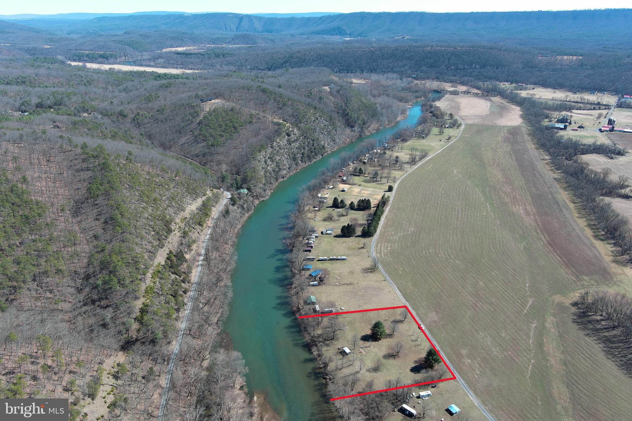RIVER RECREATION SEASON HAS ARRIVED! IF YOU HAVE BEEN WAITING FOR A LOT ON THE SOUTH BRANCH WHERE YOUR CAMPER ISN'T STACKED ON TOP OF THE NEIGHBORS, THIS COULD BE IT! 4 FLAT ACRES COMPRISED OF 2 ADJOINING LOTS WITH WELL , SEPTIC, ELECTRIC, A METAL PAVILION AND 2 CAMPER HOOKUP SPOTS. EASY ACCESS FROM RT. 28 BETWEEN SPRINGFIELD AND ROMNEY. THE SOUTH BRANCH IS KNOWN FOR EXCELLENT FISHING, FLOATING, CANOEING AND KAYAKING. THESE DON'T COME ALONG OFTEN. NOW IS YOUR CHANCE!
