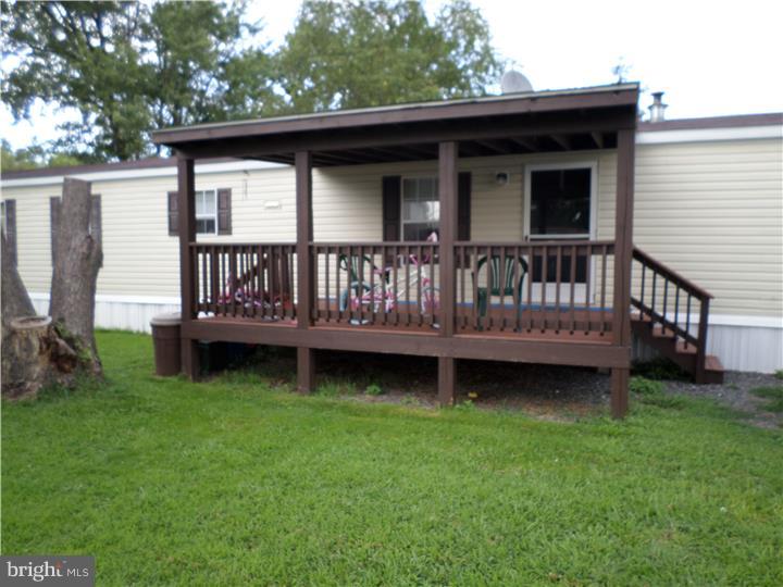 E-Z living! Come take a look at this two bedroom, two bath unit with central air! Kitchen will wow you, with gas stove, built in dishwasher and extra cabinetry, island bar and work space. Vaulted living room ceiling opens up the room! Bedrooms are separated and generously sized! Main bedroom has full bath. Second bedroom is located in the front, and has access to a full hall bath. Low taxes! Own your own four walls! No pet policy by management company. Management company is in the near process of repairing streets.