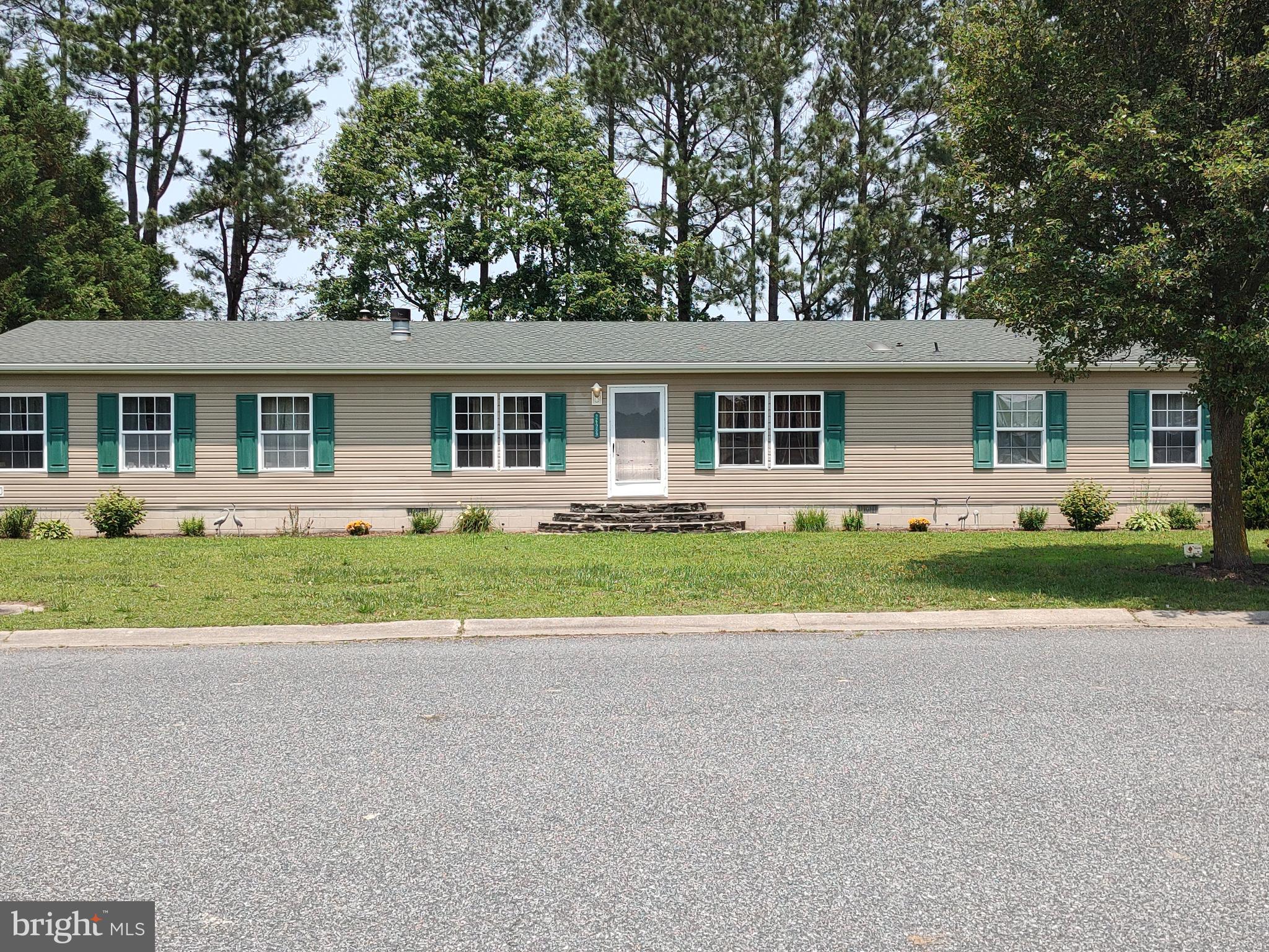 Nicely maintained home in the desirable community of Hebron Woods. You have full view of the pond from the front of your home. Fishing is allowed but it is catch and release! Home has 2052 +/- sq ft of living space with four bedrooms and two full baths and a half bath in the utility room. In the master suite is a retreat room to sit and watch TV or just to read a book and a whirlpool tub in the master bath. Home also features a spacious LR and FR off the kitchen area for entertaining family or having guest over for dinner. Home has painted drywall in the LR, master bedroom, DR and FR. There are granite countertops in the kitchen and a sliding glass door off the kitchen that takes you onto the huge 16'X24' deck so you can sit outside and enjoy the peace & quiet or have a barbeque with the family. In the LR is a wood burning fireplace with stone surround and built in shelves on both sides. There is an oversized driveway to allow more parking spaces when company comes over. Two wall mounted TV's in the master bedroom and FR that will stay with the home. So come and see all that this home has to offer. Home is being sold as-is. Lot rent includes your water, sewer, trash pickup and property tax on your home. Expected date on the market is 6/14.