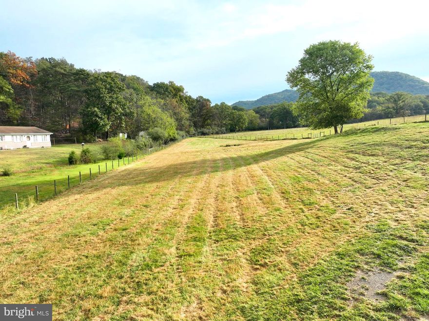 Escape to the open countryside and make this 1.50-acre parcel near the Hampshire–Hardy County line your own. Perfectly situated just off U.S. Route 220, this property offers the best of both worlds — peaceful rural living with quick access to modern conveniences. You can be in Moorefield in minutes or reach the I-81 corridor near Winchester, Virginia, in just over an hour via Corridor H. The land is 100% open and fully usable, mostly fenced for livestock, and features a small pond framed by big mountain views. Public water and electricity are available along the access road, and the owner reports a 3-bedroom septic system is already in place. With no restrictions, you’ll have the freedom to build, farm, or simply relax and enjoy your own wide-open space in the country.