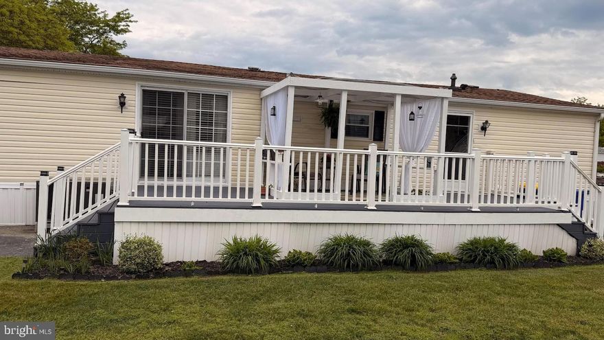 Step into effortless, one-level living. This mobile home,  with modern updates, is nestled within the serene  Ridgewood Manor in Smyrna, DE. Designed with both comfort and style in mind, this 3-bedroom, 2-bath home invites you to savor the best of simple, modern living. Start your mornings on the inviting back porch, where you can enjoy your coffee and the peaceful surroundings. The exterior also features off-street parking and a cozy patio—perfect for relaxing or hosting friends. Inside, the floor plan welcomes you with abundant natural light, creating a warm, airy atmosphere. The heart of the home is the living room with a fireplace, where you can cozy up on those cool winter nights. The kitchen has plenty of cabinet space and includes a stainless steel stove/range, microwave, dishwasher, and refrigerator.  appliances are in as-is condition. A convenient laundry room with a washer and dryer is included, and a side entrance adds to the space's practicality. Whether you're downsizing or looking for a low-maintenance lifestyle, this home delivers comfort, convenience, and a touch of luxury. Don't let this opportunity pass you by—your perfect retreat awaits! Property is sold, as-is, by the seller.