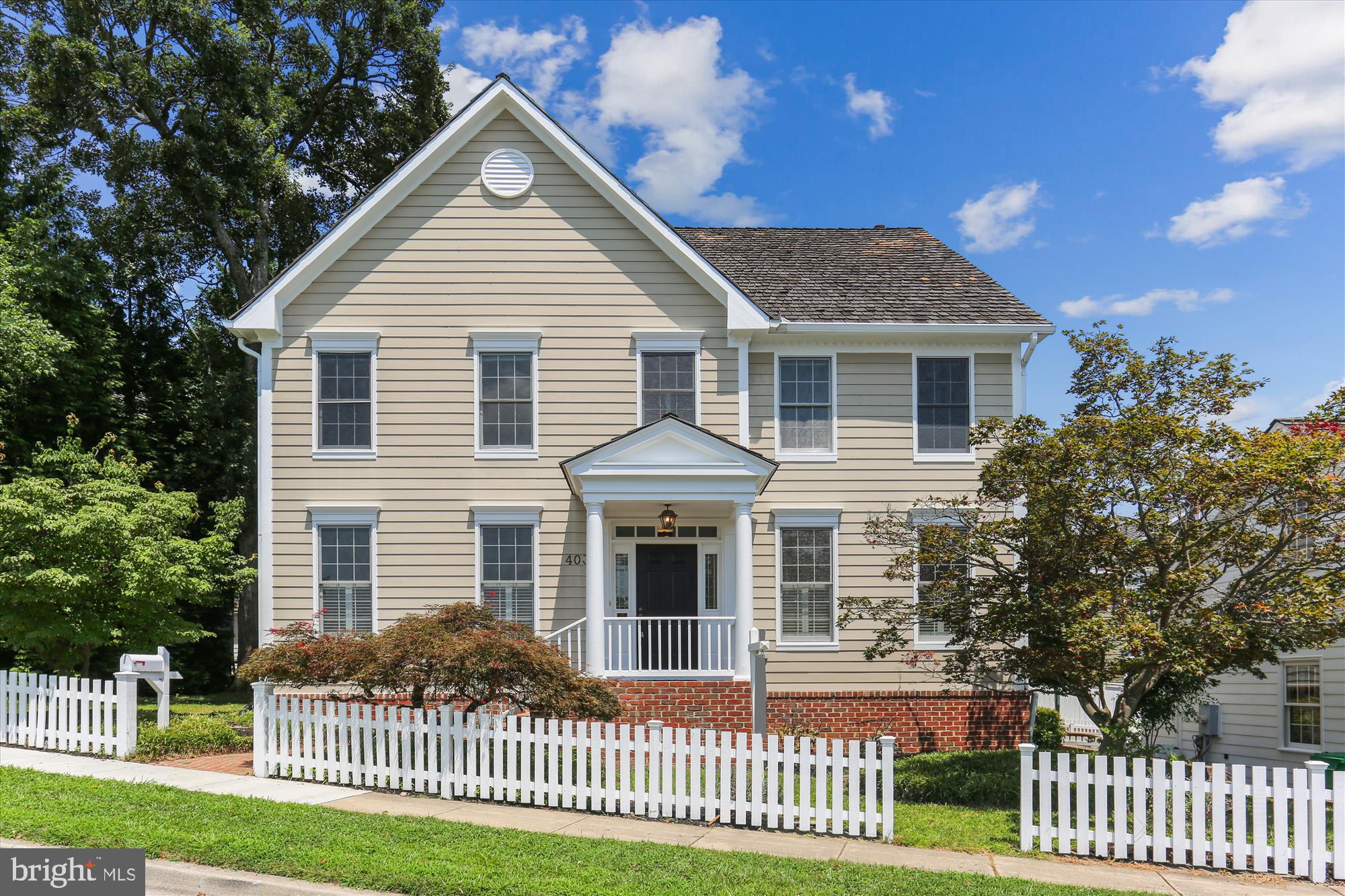 This beautifully designed Kentlands home offers spacious living and beautiful updates throughout. Hardwood floors flow through the main level, from the formal living room and elegant dining room—both featuring crown and chair rail moldings, shutters, and decorator lighting and into the inviting family room. Here, a gas-burning fireplace is flanked by custom built-ins, and a dramatic two-story wall of windows offers a view to the deck and upper-level overlook. The kitchen features wood cabinetry, a large central island with cooktop, stainless steel appliances, recessed lighting, and a sunny breakfast area. A double window provides ample light, while a French door leads directly to the deck—perfect for everyday living and entertaining. The adjacent butler’s pantry and breakfast area are finished with tile flooring and elegant moldings. The main level also includes a renovated powder room with a furniture-grade vanity and decorator fixtures, a private office with tray ceiling, and a spacious mudroom/laundry area with built-in cabinetry, shelving, and garage access. The attached garage includes a newer door and pull-down attic access. Upstairs, the expansive primary suite showcases a vaulted ceiling, a generous sitting area, two walk-in closets, and a vestibule with updated lighting. The en-suite bath includes a jetted soaking tub, dual-sink vanity, glass-enclosed shower, and compartmented WC. Three additional large bedrooms offer recessed lighting, double-door closets, and ceiling fans, and share a second full bath with a tub/shower, compartmented WC, and a double-door linen closet. The finished lower level provides exceptional bonus space with a versatile rec/media/game room, a den/bonus room with recessed lighting, and a full bath with updated fixtures. A light-filled bonus room with walk-up access adds additional flexibility, ideal for a craft room or fitness area. The workshop offers even more functionality. Additional features include a 2019 roof, updated HVAC (2022/2023), a newer water heater, and a Nest system. The deck and landscaped outdoor areas enhance the home's appeal, offering comfortable spaces for outdoor living. With abundant daylight even in the basement, this home feels bright and spacious on every level. In a prime location, this home provides quick access to Rachel Carson Elementary School, nearby parks and playgrounds, the exceptional Kentlands recreation facilities, and the vibrant Kentlands Downtown with countless dining, shopping, and entertainment options.