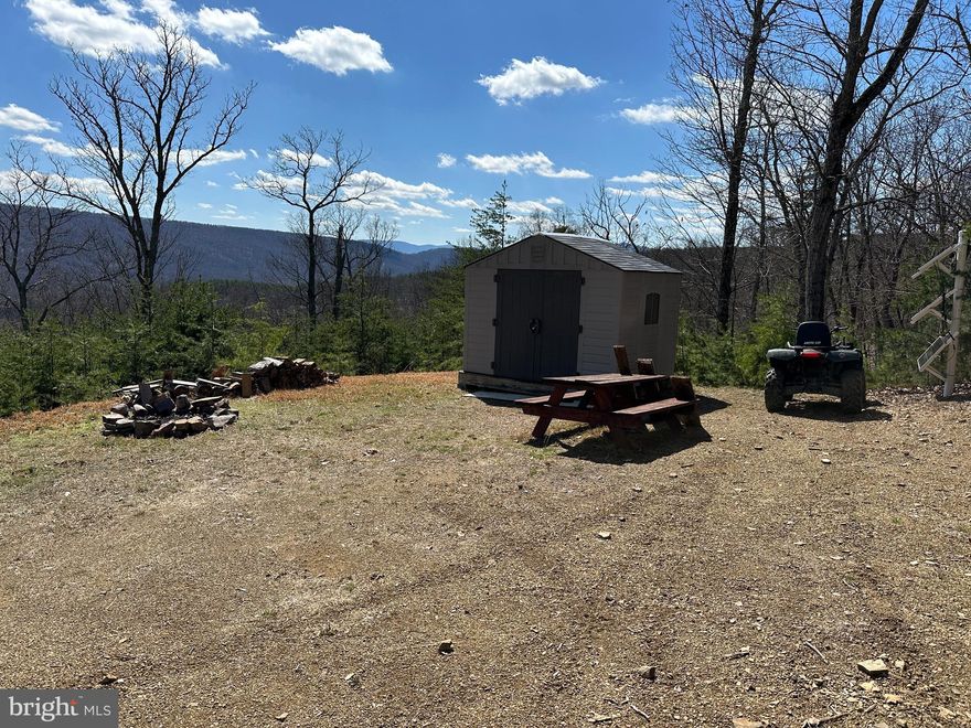 CHECK EVERY BOX ON YOUR LIST......24 WOODED ACRES WITH DRIVEWAY INSTALLED TO BUILD/CAMP SITE WITH STUNNING SOUTHERN VIEWS. COMES WITH GOOD TIMES STARTER KIT: SHED, PICNIC TABLE, FIRE RING & SOLAR PANEL BANK FOR SMALL CAMPER OFF YOU WANT TO STAY OFF GRID. EASY TO BUILD ON, POWER & PERKED, ELECTRIC 200 YARDS FROM BUILD SITE.....YOU'RE AT LEAST 10K AHEAD OF THE GAME ON INFRASTRUCTURE COSTS WITH THE DRIVEWAY & CLEARING ALREADY DONE. AWESOME TREE HOUSE/HUNTING BLIND IN PLACE, STAY OUT OF THE COLD WHILE YOU'RE WAITING FOR MR. BIG TO WALK BY. SMALL WET WEATHER STREAM WITH MULTIPLE WATERFALLS & OVER 1/2 MILE OF ATV TRAILS ON THE PROPERTY. LOCATED IN THE PRESTIGIOUS GATED COMMUNITY OF "THE BLUFFS ON THE POTOMAC".....THE BLUFFS IS KNOWN FOR IT'S ABUNDANCE OF BIG BUCKS, BEAR & TURKEY. AS AN ADDED BONUS, THE COMMUNITY HAS IT'S OWN PRIVATE COMMON AREA ON THE SOUTH BRANCH OF THE POTOMAC RIVER FOR CANOE, KAYAK, TUBES, FISH & SWIM......A PRIVATE PARK ON THE RIVER FOR YOUR SUMMERTIME ENJOYMENT. BUILD, CAMP, HUNT, HIKE, ATV'S, SHOOT......ENDLESS OUTDOOR ACTIVITIES AT YOUR FINGERTIPS.....A STUNNING PROPERTY THAT'S READY TO ENJOY....THIS PROPERTY IS SURE TO CHECK EVERY BOX ON YOUR LIST!