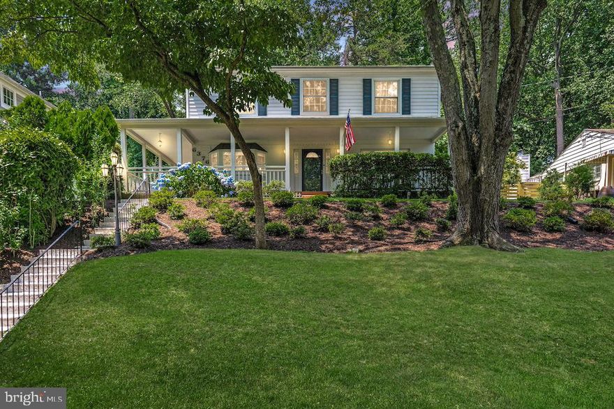 This beautifully updated home sits on a serene and picturesque lot in Falls Church, Virginia. The wrap-around porch invites relaxation. Inside, large picture windows fill the open living, dining, and family areas with natural light. The updated kitchen boasts modern appliances.   A convenient half bath completes the main level. Upstairs, the spacious primary bedroom features a sitting area, a remodeled en suite bathroom, and ample closet space. Three large bedrooms share a renovated hall bath, offering comfort and versatility for family or guests. The outdoor space is a true retreat. With more than a third of an acre, the property includes a fenced area for pets, a raised patio ideal for al fresco dining, and a large private backyard with endless possibilities for gardening and outdoor activities. Falls Church offers diverse dining options, cultural opportunities, and easy access to shopping and everyday essentials. Nearby recreational opportunities include Holmes Run Stream Valley Park, Mason District Park, and the W&OD Trail. Proximity to I-66, the Beltway, and metro stations makes commuting to Washington, D.C., and beyond easy. More than just a house, this is a place to call home.
